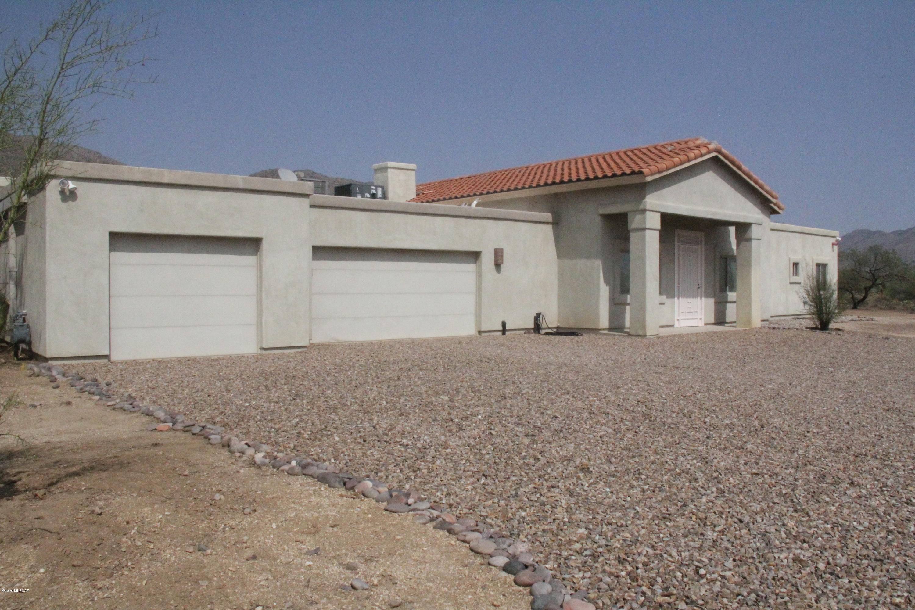 Located on 3.35 acres, this custom 4424 sq.ft. home zoned for horses & NO HOA. The pristine open floor plan w/high ceilings features a newly remodeled Gourmet Kitchen w/oversized island, indoor grill w/6 burner gas cooktop, double ovens, convection microwave oven, 2 GE Profile SS dishwashers, SS farm style sink, wine cooler, oversized side by side SS refrigerator/freezer & sleek cherry cabinets.  3 living spaces, 5 bedrooms including 2 master  en suites, 3.5 bathrooms plus workout room/nursery. Master bath includes walk in shower w/rain head & built in bench & luxury Jacuzzi tub.  Luxury remote doors open the Great Room to the covered patio & amazing Catalina Mt views. Spiral staircase to rooftop observation deck for sunset views. 3 car garage w/ample storage & air conditioned work room.