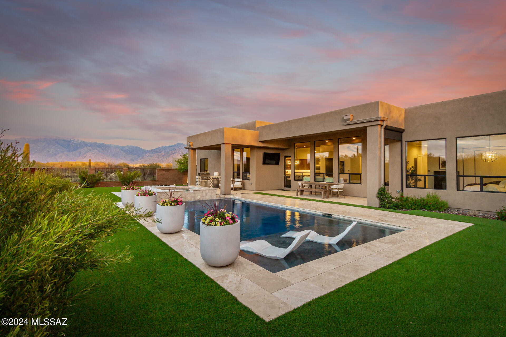 Luxurious living at its best! This sophisticated dream home is a rare find nestled on a quiet cul-de-sac, it boasts a 3-car garage, an easy-care desert landscape, and a gated courtyard. The stunning interior showcases a modern open layout featuring tongue and groove ceiling treatments as well as designer touches throughout. A blend of wood-look tile & carpet flooring, neutral palette, and contemporary light fixtures are found throughout. Gorgeous chef's kitchen is equipped with SS appliances including a large Sub-Zero refrigerator, wall oven, high end dishwasher & a gas cooktop, a ample pantry, Monte Blanc quartzite counters, beautiful wood cabinets adorned with crown moulding, subway tile backsplash, and a center island with a breakfast bar. Grand owner's retreat overlooks the backyard, complete with an ensuite with two vanities, floor to ceiling tile shower and a walk-in closet. Large size additional bedrooms. Don't miss the Jack & Jill bathroom! A flexible den and bonus room add to this gem's appeal. Enjoy the resort style backyard with incredible mountain views, a covered patio, a built-in BBQ, a fire pit, a refreshing pool, and a spa. This dream home has everything you're looking for!