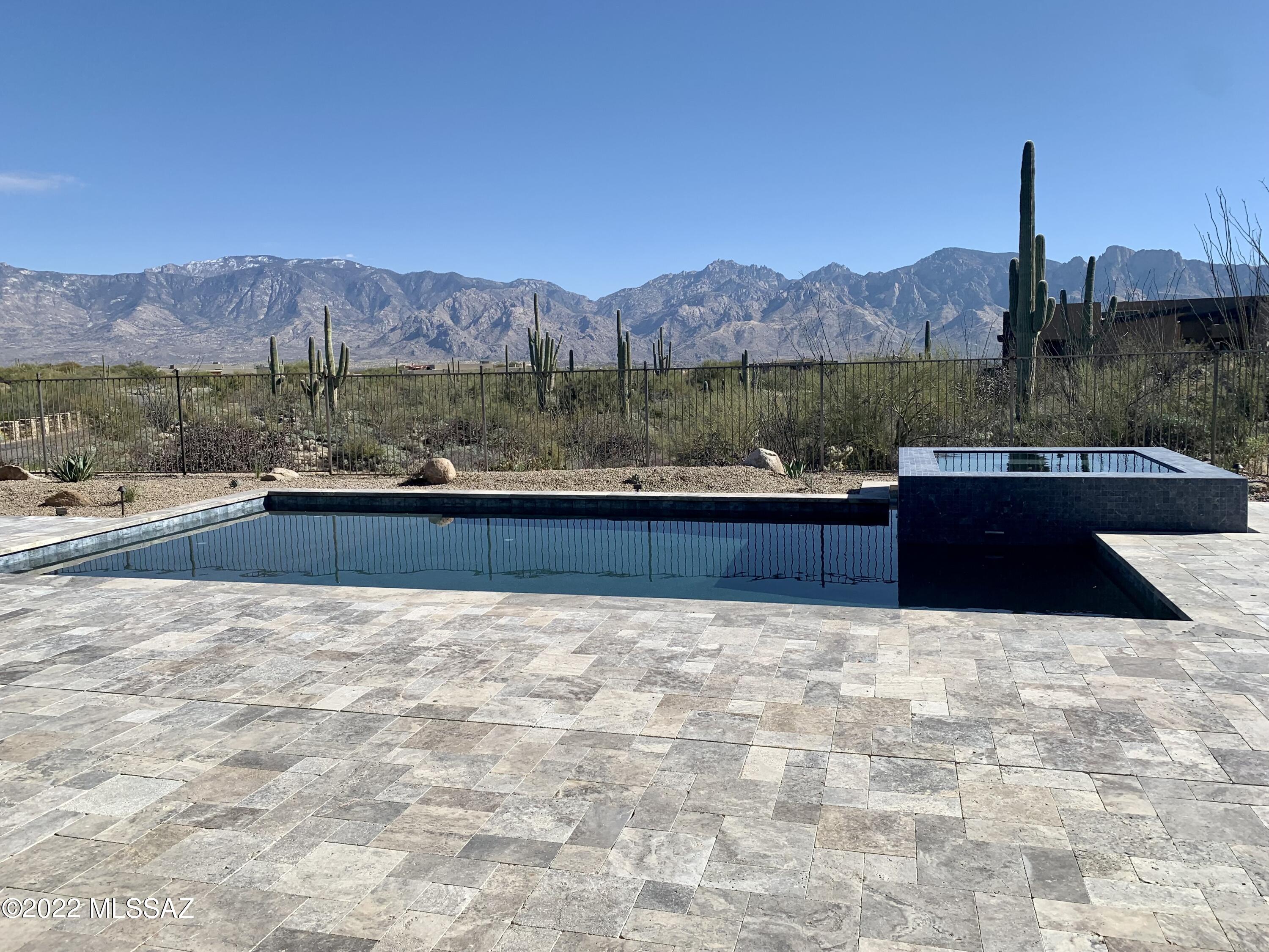 Find your desert paradise in this exquisite 3 bed, 3.5 bath home.  This luxurious design features meticulously crafted space engineered to optimize the striking views from every window. Enjoy the freedom to unwind and entertain with an expansive great room + expansive covered patio with breathtaking views, pool, spa and so much more- all on a private 2.5 acre lot.  Sleek, modern appliances and amenities fit harmoniously with the home's grand design, all nestled into a premiere lot with unobstructed views of the vast Catalina Mountains.
This property is located in the sought-after Stone Canyon community, exclusive + gated. Featuring a Health and Fitness Center, Clubhouse and Jay Morrish- designed world-class golf course. Come home to your private piece of paradise!