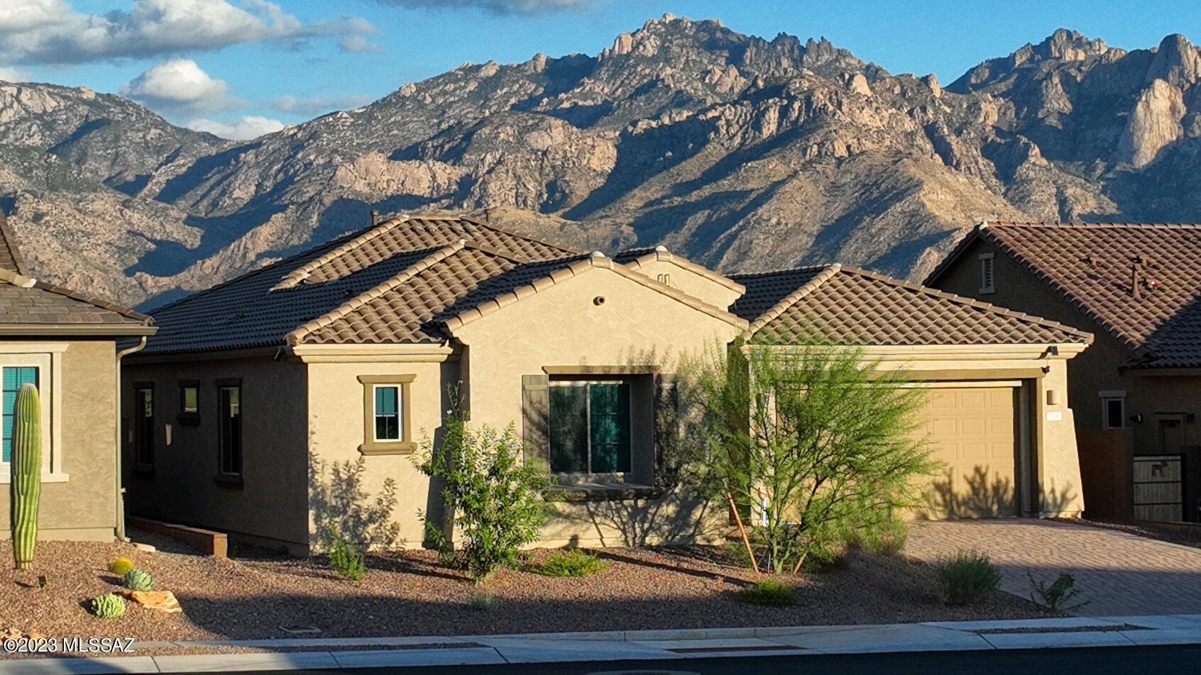 Welcome to your dream home in the sought-after Valley Vista community of Oro Valley! With a serene ambiance and meticulous attention to detail, this property is the epitome of comfortable living. Upon entering the home, you'll be greeted by an open and inviting floor plan that seamlessly flows from room to room. The living area is a cozy haven with large windows and an extended double slider that floods the space with natural light. The heart of the home is the fully-equipped kitchen, complete with modern appliances, ample storage, and a waterfall island to serve as a gathering space. Enjoy having two primary suites, with one serving perfectly as a mother-in-law suite including its own living room. The standout features of this home include the refreshing pool and spa, as well as the spectacular Catalina Mountain views. Imagine spending your summer days lounging by the pool or fireplace while gazing at the breathtaking mountain vistas.The covered patio offers shade and a place to savor al-fresco dining or simply unwind with a glass of wine as the sun sets behind the Catalinas. The Valley Vista community in Oro Valley is known for its natural beauty, with stunning landscapes and convenient access to hiking trails, parks, and outdoor adventures. You'll be in close proximity to shopping, dining, and top-rated schools, making this location highly desirable.