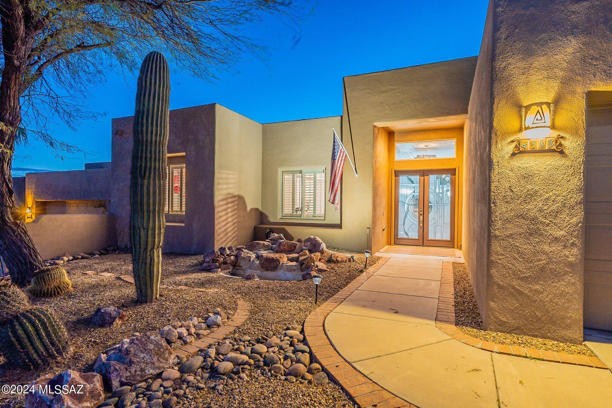 Stunning contemporary hm in coveted gated community offering panoramic Catalina mountain views & vibrant city skyline! Tastefully remodeled, open concept plan w/tons of natural light joining inside & outside living-perfect for relaxing or entertaining. Lg great room & gourmet chef's kitchen w/custom cabinetry, upgraded appliances, countertops galore & expansive island w/brkfast bar. Private primary retreat w/beautiful views, two closets, door to patio & updated bath w/extended dual sink custom vanity. Perfect outdoor living w/low maintenance landscape, nice covd patio & remodeled mini pebble tec pool w/lagoon. A perfect retreat to soak in the beauty of the desert or host large gatherings! Owned solar & conveniently located near shopping, dining & outdoor recreation. Don't miss this beauty