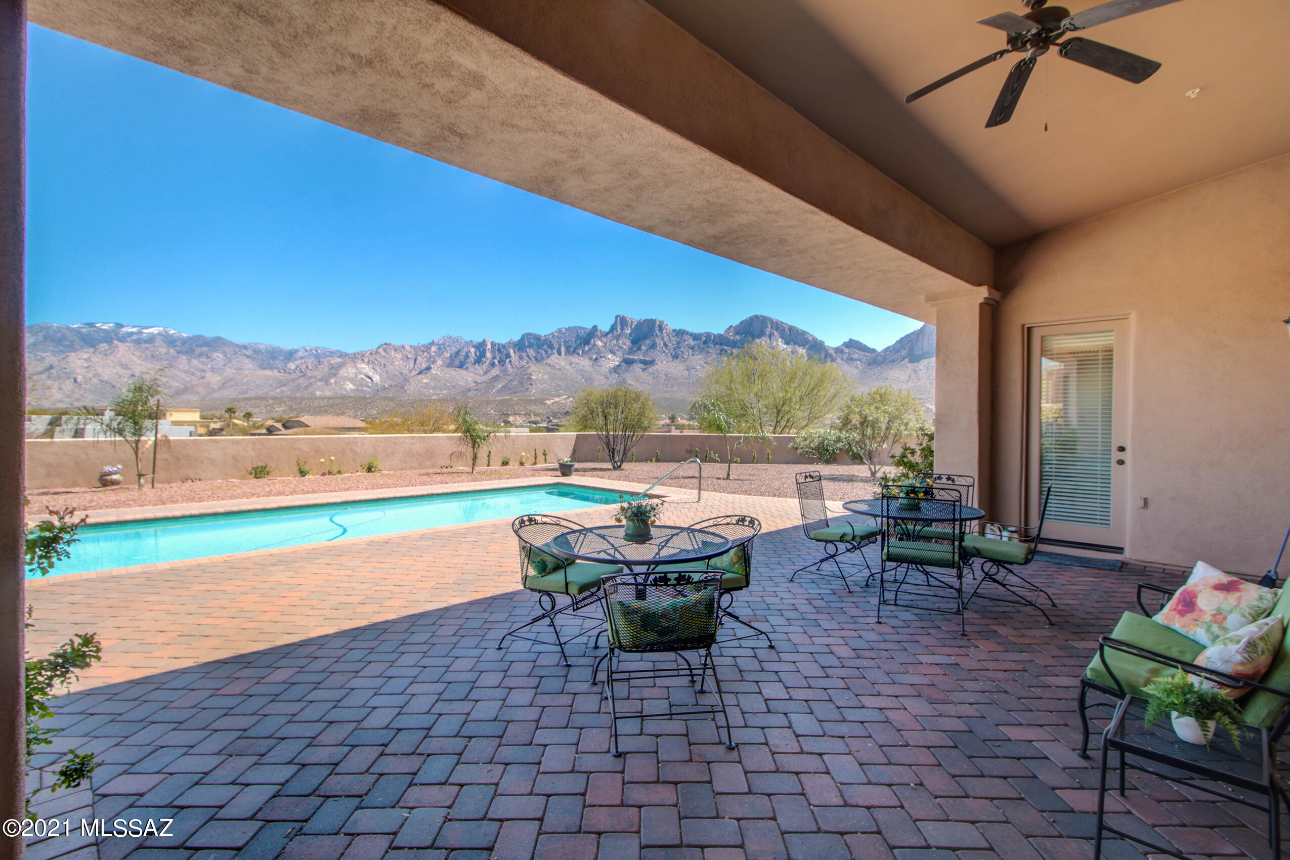 Breathtaking Majestic Views of Pusch Ridge and Catalina Mountains from almost every room. Enter into the formal living and dining rooms with a wall of windows looking out to the gorgeous backyard. 
Gourmet kitchen boasts double ovens,  5 burner gas stove, double pantries, granite counters.  huge center island and eat-in area.  Great room has bay windows, extended built-in cabinets. Door leads out to your resort backyard w/ pool and extensive brick paver covered patio.  Oversized master suite w/ sitting area and his & her walk in closets. Master bath has double vanities, lg walk in shower and soaking tub. Split bedroom plan w/ 4 additional bedrooms & 2 baths, Oversized 3 car garage. This almost acre lot has plenty of room to build an HOA allowed guest house.