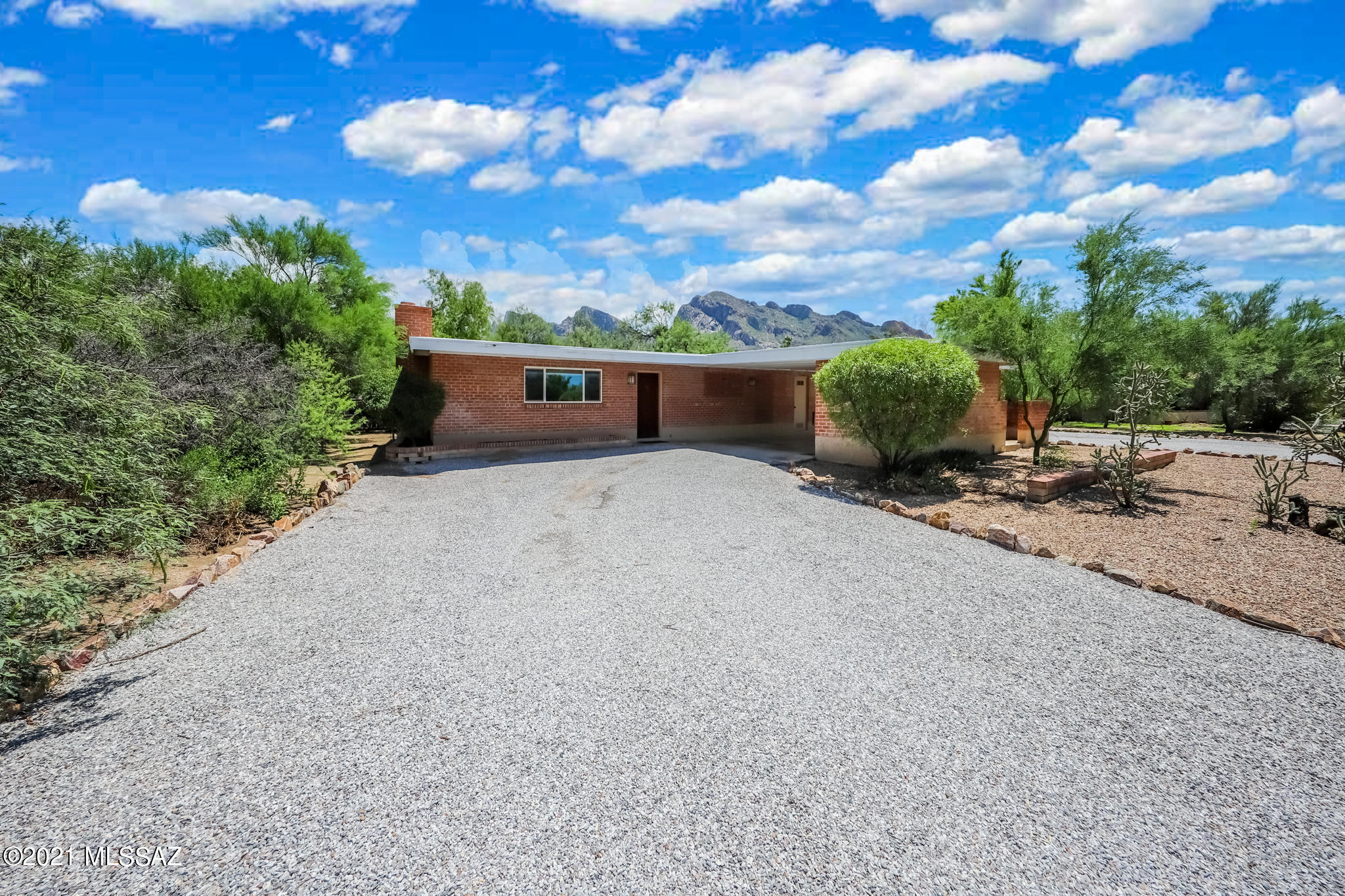 Updated home in the heart of the coveted Oro Valley Estates. Mature trees, a view of Pusch Ridge at every turn, and a long established golf community welcome you to this loved home.  Situated nicely on this large .93 acre lot, with a full backdrop of the Catalina Mountains, this home with updated kitchen, granite countertops and wood burning fireplace can be your quiet retreat or your blank canvas with lots of space to develop.