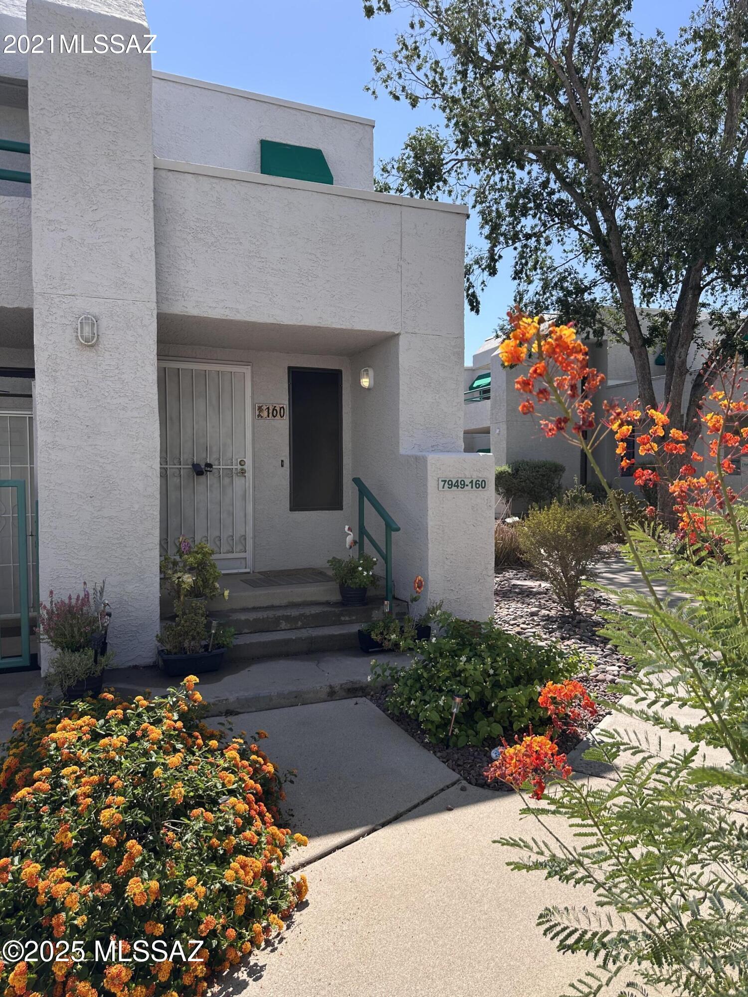 THIS IS A MUST SEE!!!  Large corner floorplan on second floor location between the two pools. This unit has one covered carport  space behind the building.  Newer full size stacked Washer & Dryer in hall closet, A/C replaced in last 3 years, new storage doors on private balcony with updated decking.  New stove, range hood, lighting in breakfast nook, dining room and ceiling fan.  Den and living rooom enjoy a double sided fireplace, with spacious bedrooms, great lighting, and a multiple function floorplan this is the largest model in Summertree.  It also has solar screens on bedroom and patio windows.