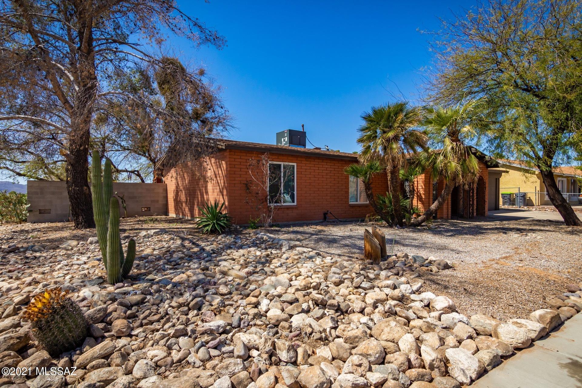Beautifully Remodeled Ranch Style Home w/handsome wood ''look'' tile floors, upgraded lighting, trending palette, window blinds,  ceiling fans, & open floor plan. Gorgeous new kitchen features a center island, quartz counters, breakfast bar, SS appliances, pantry, & beautiful white cabinetry w/crown moulding. This incredible home shows like a ''Model''. French door to patio from dining area. New plush carpet/padding in all bedrooms, ample closets, upscale bath w/designer tile, fixtures, quartz counters, & an interior laundry room. Epoxy garage floor w/storage. Huge backyard w/shade trees, covered patio, & room for a pool! NO HOA!  Do not miss out on this desert gem.