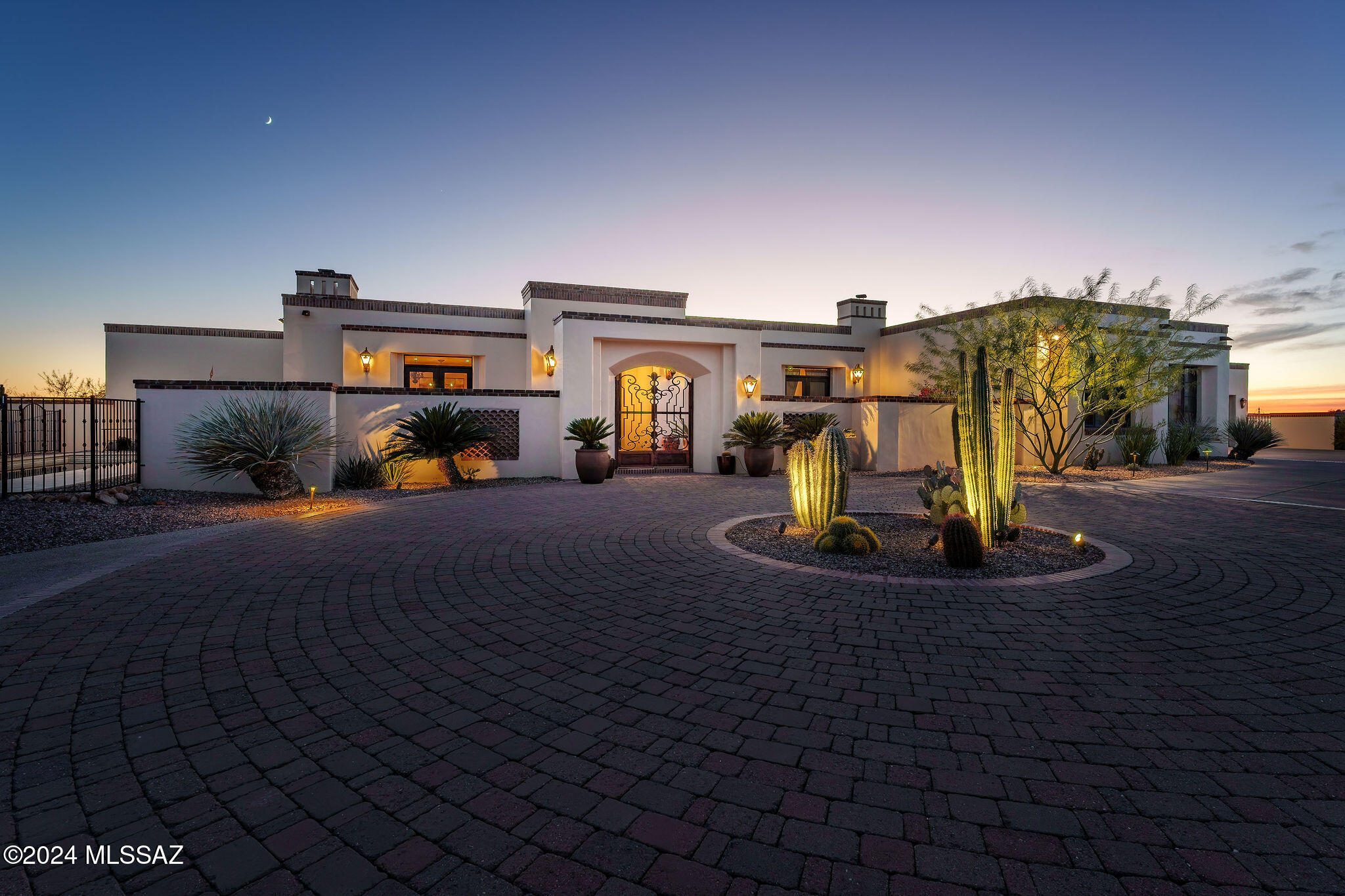 Discover this incredible hilltop property located on 2.25 acres in the prestigious Catalina Foothills Estates. Breathtaking city and mountain views create a stunning backdrop for luxurious living. The front courtyard welcomes you into the grand foyer entry, showcasing meticulous attention to detail that you will find throughout the home. Expansive gourmet kitchen features 6 burner Dacor dual fuel range with pot filler, Sub-Zero refrigerator, 2 DW, huge custom island with seating, a prep sink and warming drawer. Don't miss the walk in pantry and the temperature-controlled 500 bottle wine room!  Exceptional design includes wood cased doorways; natural stone; custom trim work; built in library in living room; fireplaces in family room and living room; 8' Knotty Alder doors; 8 inch baseboards ; speakers throughout. Primary suite sanctuary offers a cozy fireplace, customized walk in dressing room and luxurious bathroom. The 2 guest bedrooms have on-suite baths and walk in closets. 4th room is a large office featuring custom cabinetry, walk in closet and a private deck that offers a serene workspace. Dramatic back patio is an entertainer's dream with pool & spa, fireplace and ceiling mounted gas heaters, providing a perfect alfresco setting with built in BBQ & dining area. Back patio leads to a fully equipped gym with full bath that could serve as an additional bedroom. Great space for enhancing your wellness routine with direct access to the newly added salt water, heated and mechanically covered lap pool for year-round fitness! Oversized 3 car garage with storage and a workshop area. Owned solar voltaic system!