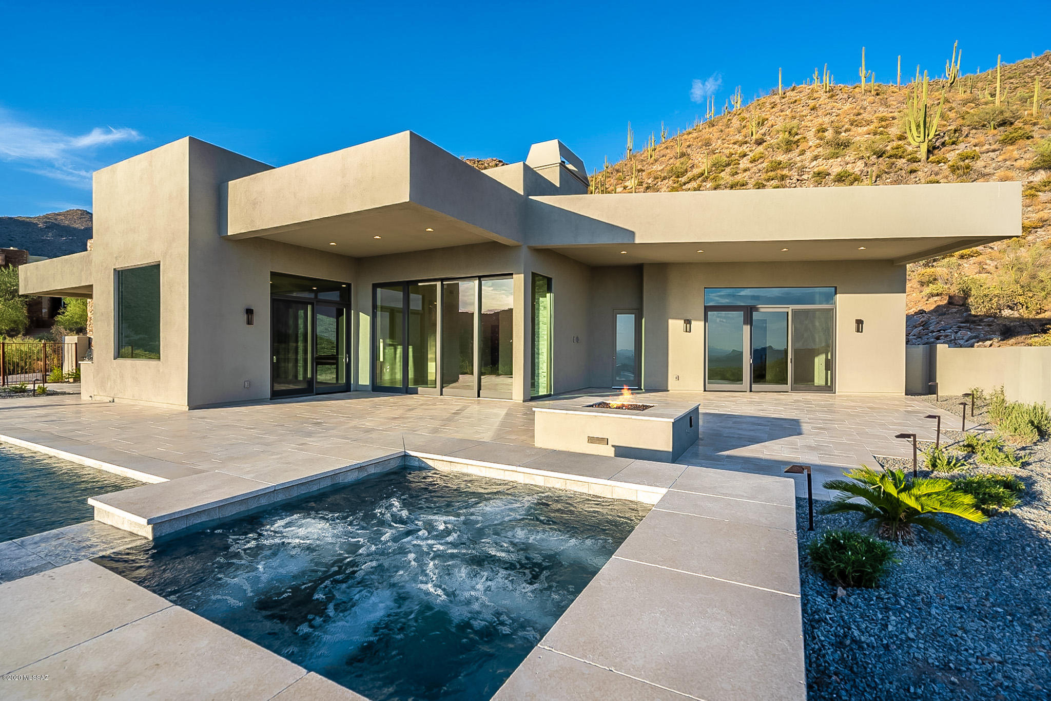 Luxurious contemporary home just completed by Maccarone Homes. Located in Canyon Pass at Dove Mountain, this home is on a 1.8 acre lot overlooking the 5th green of the North Course at the exclusive Gallery Golf Club. Enjoy unparalleled views from an open concept design of city, mountain, and natural desert. The front courtyard opens to an impressive great room with 15 foot ceilings, a floor-to-ceiling stone fireplace, a state-of-the-art gourmet kitchen and custom wet bar. The spacious master suite includes a fireplace, elegantly appointed bathroom and large walk-in closet with built-in storage. Enjoy the quintessential indoor/outdoor desert lifestyle with 10' retractable glass sliders that open to your backyard oasis. This stunning beauty leaves nothing to be desired!
