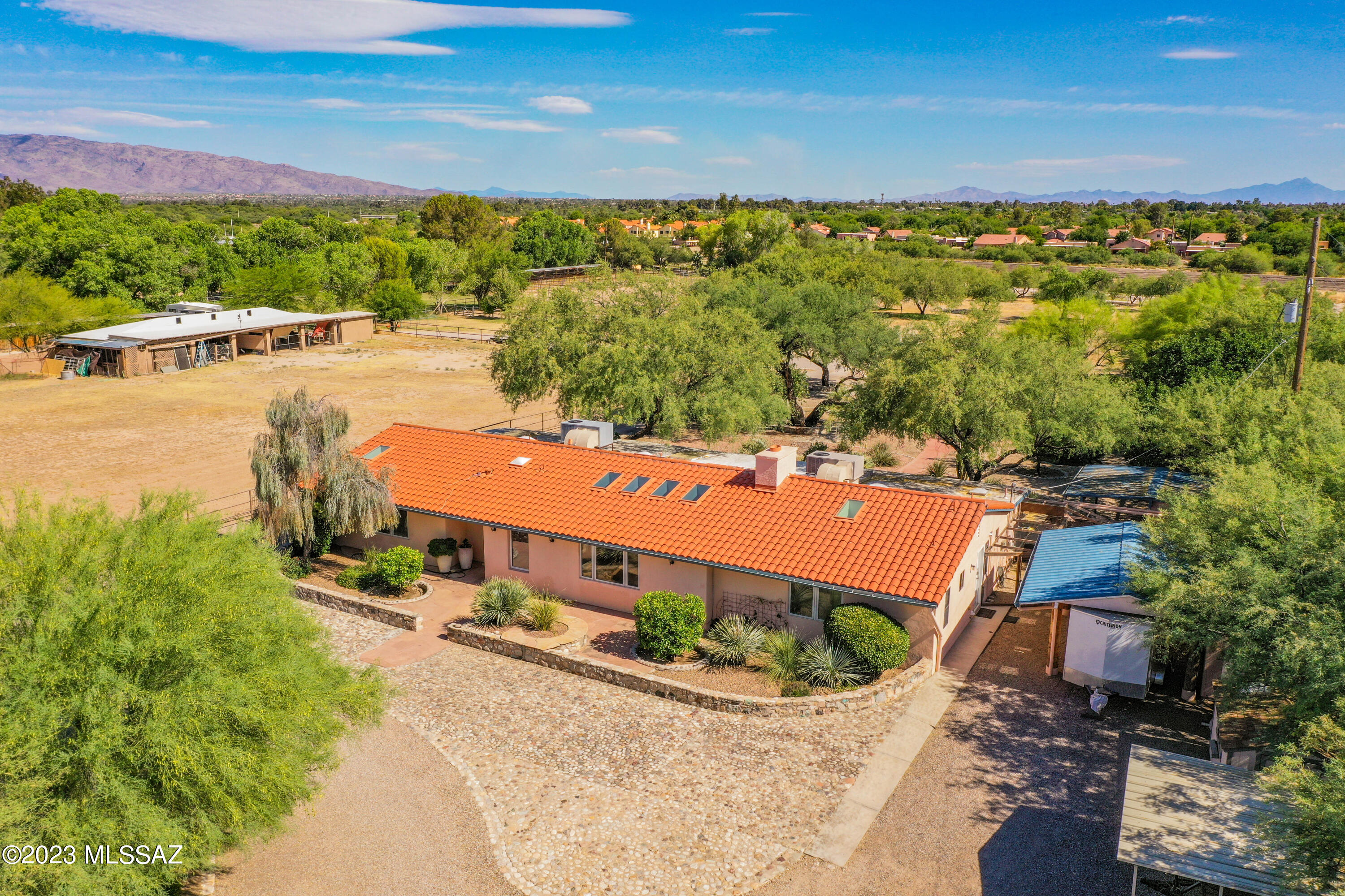 4.59 Flat Acres w/ wash access! Private & peaceful gated home in a very desirable neighborhood. Thoughtfully designed home with 4 bedrooms, 5 bathrooms (1 outside). Great room has plenty of skylights which allow for natural light to pour in & a beautiful stone fireplace. Ceramic tile throughout.The spacious owner's suite features an extra sitting area, perfect for a nursery, office, or workout space & a walk-in-closet, allowing for plenty of storage. Easy & flowing floor plan with two ensuite bedrooms & a hall bathroom. Fantastic backyard with fruit trees, grapevines, gazebo, dog run, & pure serenity. This property is complete with 4.59 acres of BEAUTIFUL horse property, pastures with access to the riverwalk for miles of trail riding, or outdoor activities. Private well... OWNED solar, and full RV hookup. The covered structure could be converted to horse facilities, or additional parking for the car enthusiast. This one is something special!
