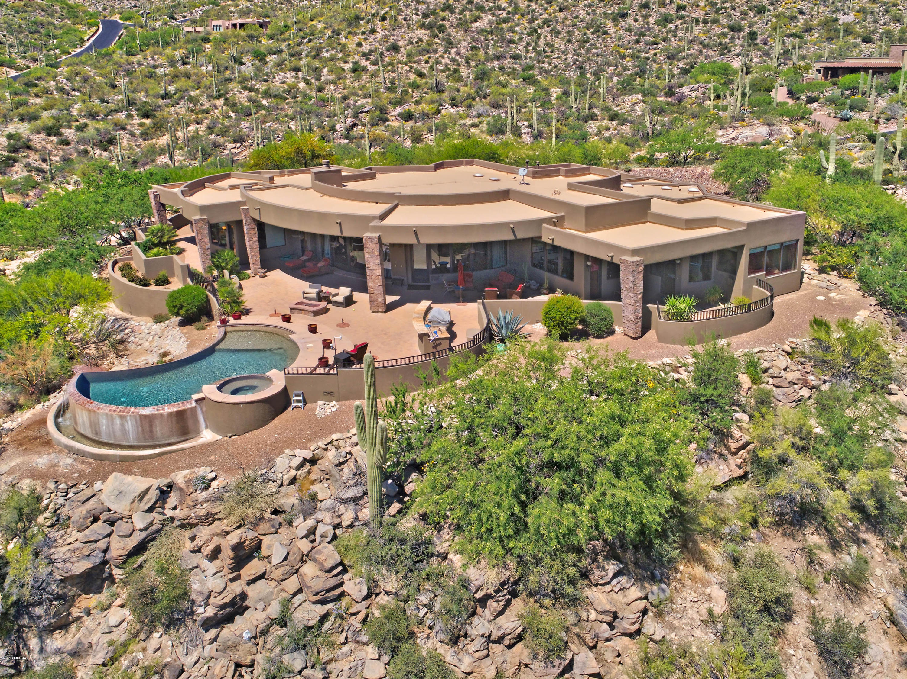 Gorgeous panoramic views throughout this stunning home.  No details have been overlooked.  The cooks kitchen is masterfully designed and appointed.  Including a huge walk-in pantry.  The impressive wall of windows in the great room opens to bring in that natural beauty.  The private master suite is a perfect retreat.  Surrounding you in breathtaking views and highlighted with a beautiful fireplace and  luxurious bath.  Outdoor living space includes expansive patio, pool, spa, built-in BBQ, firepit and more of the incredible views of Canyon Pass.  Media room/5th bdrm is perfectly outfitted to impress and entertain.  Superior finishings and elegant touches throughout make this a spectacular home, one not to miss.
