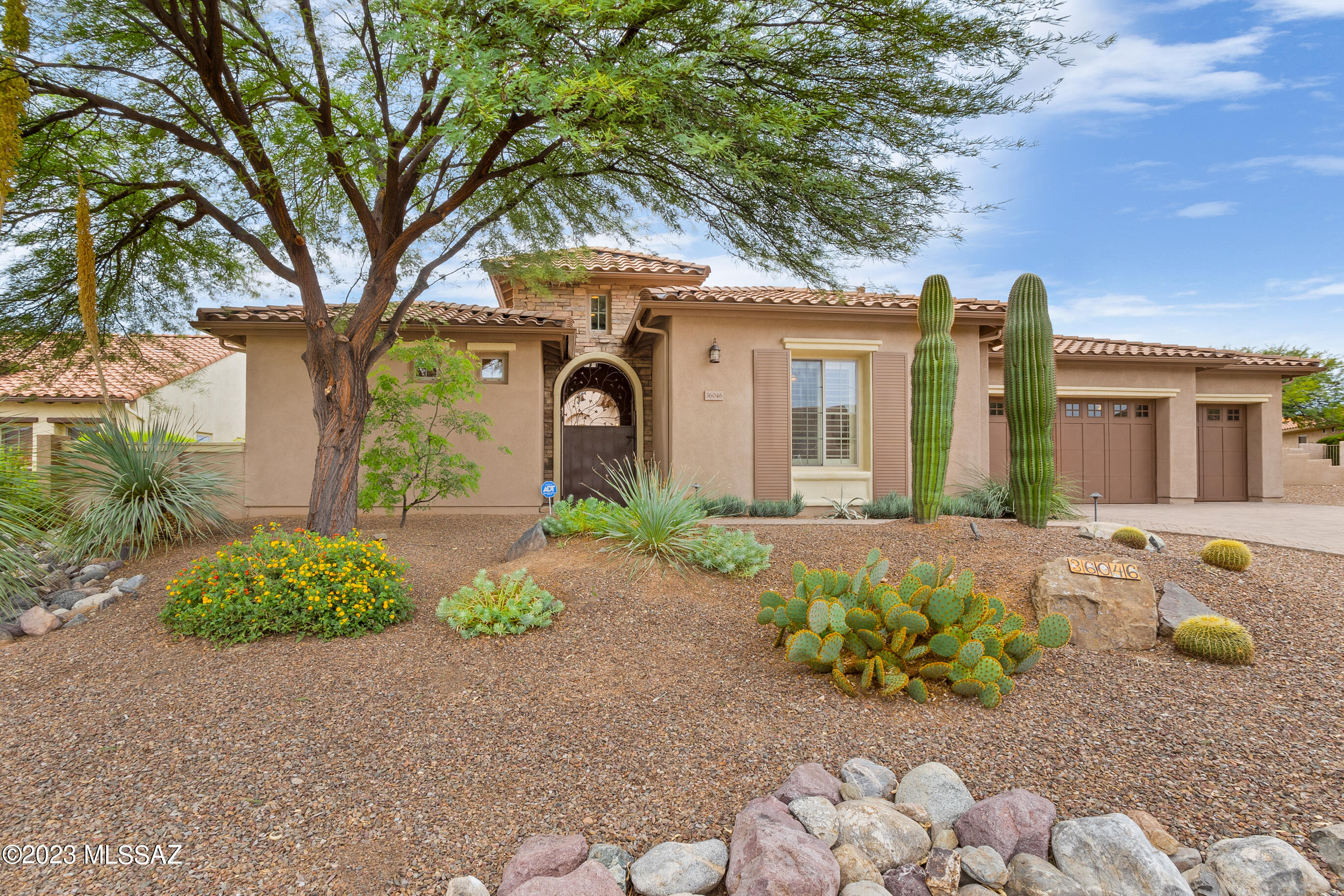 Mediterranean style Sonoran model with casita on a beautiful large lot with views of the Catalina Mountains.  Warm and inviting Southwest interior features a generous great room for entertaining with a gas fireplace and a wall of windows with glass doors that open to the covered patio.  Ideal Outdoor living space includes the built-in barbecue with serving counter, sink and refrigerator. Additional ramada cover extends shaded patio space.  Enjoy desert nights outside  in front of the gas fireplace. The kitchen offers a large center Island, bar seating, a butler's pantry with wine cooler and sink plus a walk-in pantry. A built-in refrigerator and gas cooking. Open yet separate dining room with unique ''Old Tucson'' chandelier. All furniture is available on a separate Bill of Sale. Ceiling speakers in great room, master bedroom, den and patio.
Built-in kitchen refrigerator with doors matching kitchen cabinets.
Small refrigerator in casita is behind the cabinet doors.
Property backs to open space for a peaceful, private setting.
Water fountain in backyard with switch on exterior west wall of house.
New patio ceiling fans and new small patio refrigerator.
Paver patio off the back of the house extends the length of the house plus additional patio in front of fireplace.
Paver driveway, walkway and enclosed front courtyard.
Custom iron door to front courtyard.
Fully fenced yard with double wide gate.
Kinetico water system and utility sink in garage.
Plenty of built-in garage cabinets. Epoxy coating on garage floor.
Lennox 5 ton, 16 SEER HVAC unit new in July 2020