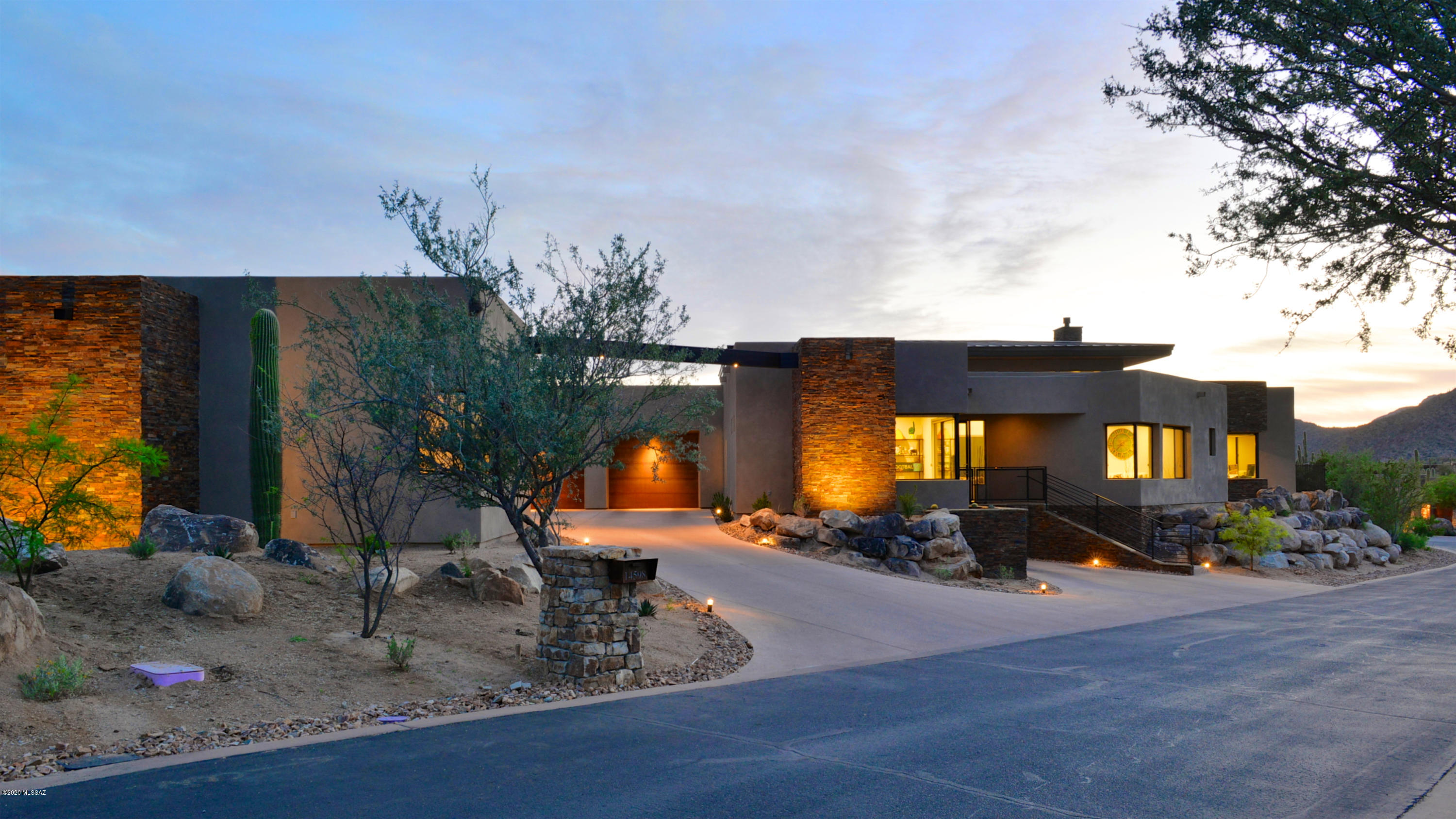 This home is a contemporary ranch style masterpiece designed by premier Southern AZ architect Ron Robinette. This home sits on a private, secluded home site of 1.03 acres.  Main house consists of 4007sqft and guest house of 507sq ft. You will be surrounded by spectacular views of rocky outcroppings, saguaros, & natural desert in exclusive Stone Canyon golf community in Oro Valley.  The open floor plan design and the wall of windows allow the outside in creating a tranquil great room atmosphere. The gourmet kitchen includes granite countertops, stainless steel appliances, gas range, that is merged with the dining and breakfast area allowing ample room for entertaining.  The split layout includes the master as well as two private guest suites, an office/den and guest house with kitchenette. Pictured floor plan has been modified, the garage has been extended to make a four car garage. Kitchen layout has been modified.  Laundry room is where the "Master Study" is located.