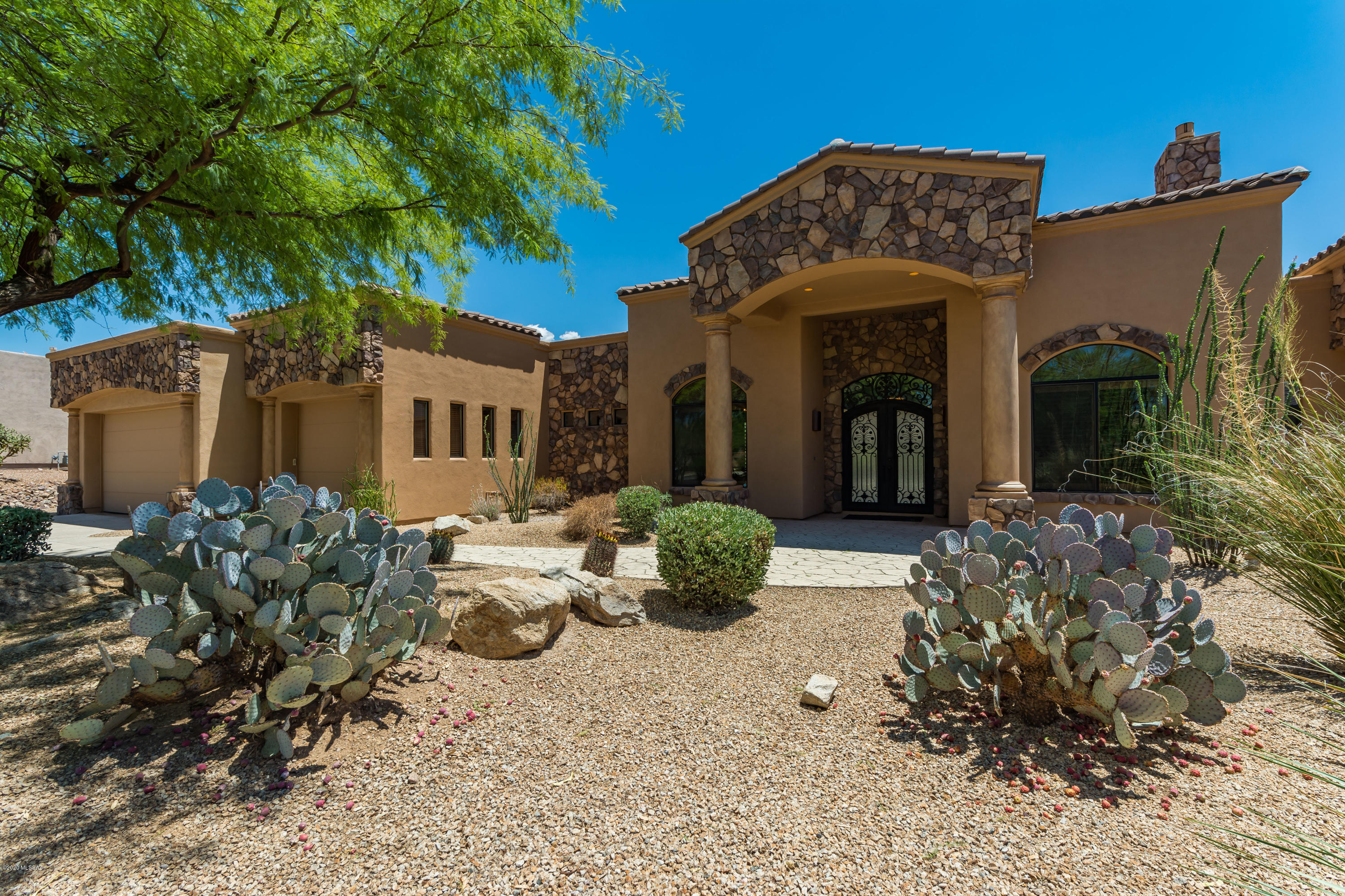 Gated. Desirable, Rancho Vistoso home is an entertainer's dream! Huge LOT! 4bdrm AND an office AND a large bonus rm. Through the beautiful double front doors you enter a large great room, w/ a formal dining & living area, features a stunning stone fireplace (all open space), you can also see an impressive built in bar, the gourmet kitchen and huge glass windows that will take you out to the fantastic backyard. This open space is inviting and warm. The gourmet kitchen has stainless steel appliances, a gas stove top with a griddle, warming drawer etc. The backyard will take your breath away with a built-in BBQ (covered), swim up bar, over sized patio, putting green, pool, spa, gas fire pit with seating, another separate grass play area & a dog run. The fun never ends in this backyard! The master suite is a sanctuary for you to retreat to. There is a peaceful sitting area near the master rm fireplace. The bathroom is grand, jetted bathtub, double vanities, and a walk in shower. The master bedroom also comes with 2 dream closets. 
The 3 additional bedrooms are sizable, two of them are connected by a jack and jill bathroom. 
This fantastic home has solar that is owned and the electric bill is VERY LOW! Garage has tons of storage space, truly a 3+ car garage... also has a work bench area. 
This home is a MUST SEE!