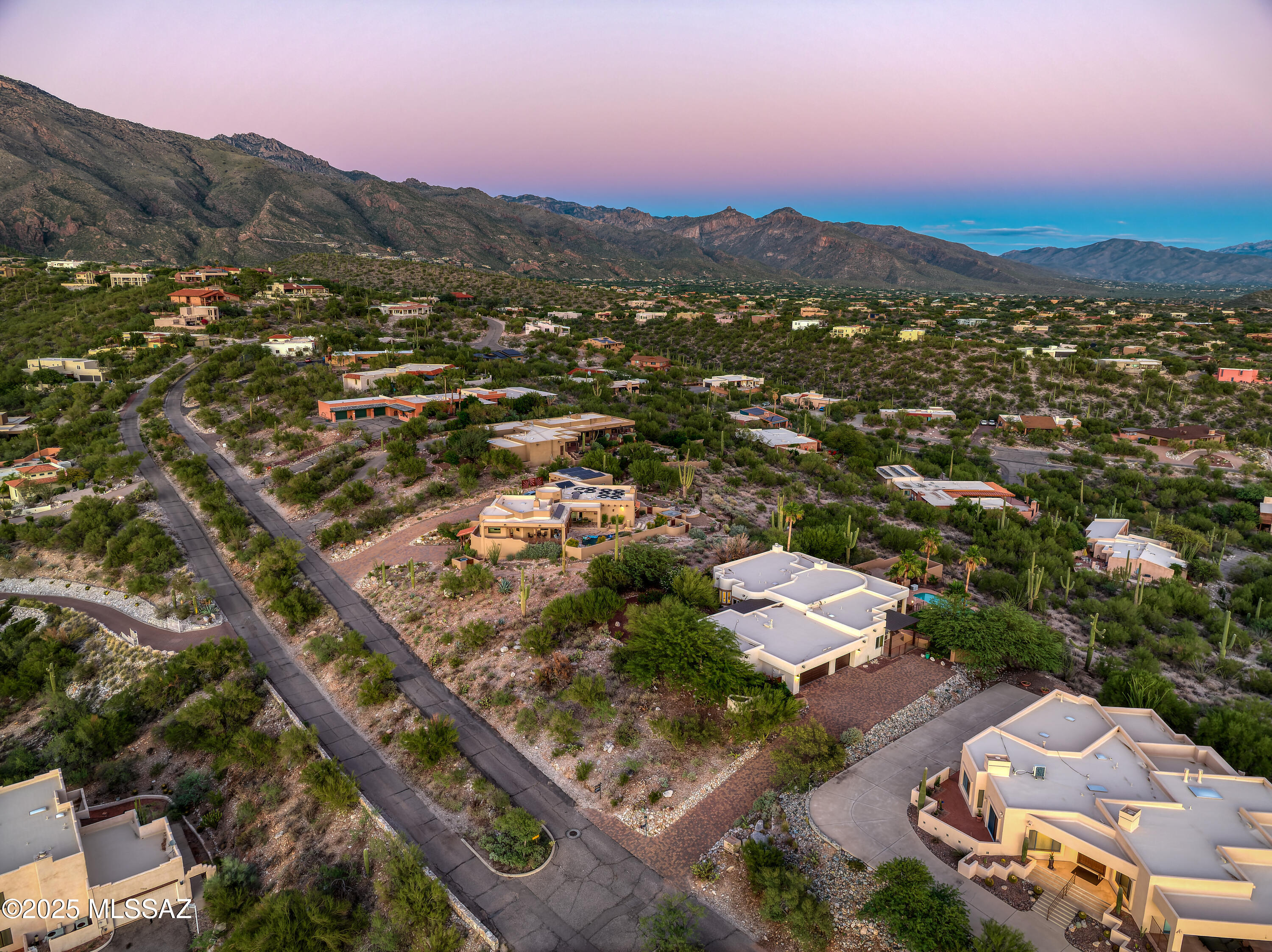 Perched gracefully on nearly an acre within the prestigious Cimarron Foothills Estates, 5588 E Paseo Cimarron represents the pinnacle of Tucson luxury living — where timeless design, impeccable craftsmanship, and awe-inspiring views converge. Perfectly positioned in the heart of the Catalina Foothills, this exceptional residence captures the grandeur of the surrounding desert landscape while offering the comfort and sophistication of a private retreat.

From the moment you arrive, the home's elegant presence is undeniable. A driveway framed by mature desert landscaping sets the tone for the understated luxury within. Enter through custom double doors to a sweeping open-concept floor plan of 3,710 square feet, designed for seamless living & grand entertaining. High ceilings, expansive windows, and artful architectural details fill each space with natural light and frame breathtaking vistas of the Catalina Mountains, Tucson city lights, and vivid desert sunsets.

The formal living and dining areas establish a tone of relaxed elegance, ideal for gatherings both intimate and grand. At the heart of the home, the great room flows effortlessly to the gourmet kitchen  a true showpiece for the culinary enthusiast. Featuring granite countertops, premium stainless-steel appliances, and custom cabinetry, the kitchen is complemented by a large breakfast bar and adjoining dining nook, creating a natural gathering space that invites conversation and connection.

The home's thoughtful layout emphasizes privacy and comfort. The primary suite, secluded from the guest bedrooms, is a luxurious sanctuary featuring a fireplace, sitting area, and direct access to the outdoor living space. The spa-inspired ensuite bath offers dual vanities, a soaking tub, a separate shower, and spacious walk-in closets. Four additional bedrooms and three full baths provide ample accommodation for family or guests, each room echoing the same attention to detail found throughout the residence.

Step outside and discover the quintessential Tucson lifestyle  a resort-style oasis designed for both relaxation and entertainment. The covered patio extends the living space outdoors, offering multiple areas for dining and lounging while taking in sweeping views of the valley below. Built-in BBQ offers outdoor cooking and entertainment, while the sparkling pool and spa are surrounded by lush desert flora and dramatic mountain backdrops, creating a setting of serenity and natural beauty. Whether hosting sunset cocktails or enjoying a quiet morning coffee, the outdoor spaces embody the best of Arizona's year-round living.

Additional highlights include a three-car garage, zoned HVAC for year-round comfort, travertine and ceramic tile flooring, two fireplaces, and refined finishes that blend elegance with functionality. Every detail has been carefully considered to create an atmosphere of warmth, sophistication, and lasting quality.

Set within the highly sought-after Catalina Foothills Unified School Districtincluding Ventana Vista Elementary, Esperero Canyon Middle, and Catalina Foothills Highthis residence also enjoys proximity to Tucson's most desirable destinations. Fine dining, boutique shopping, golf at Ventana Canyon and La Paloma, and the scenic trails of Sabino Canyon are all just minutes away, making this home the perfect fusion of natural beauty and urban convenience.

5588 E Paseo Cimarron is more than a homeit is a statement of refined desert living, where elegance meets comfort and every detail is crafted to enhance the way you live. From its commanding views to its artfully designed interiors, this home offers an unparalleled opportunity to experience the very best of Tucson's luxury lifestyle in one of the city's most distinguished communities.
