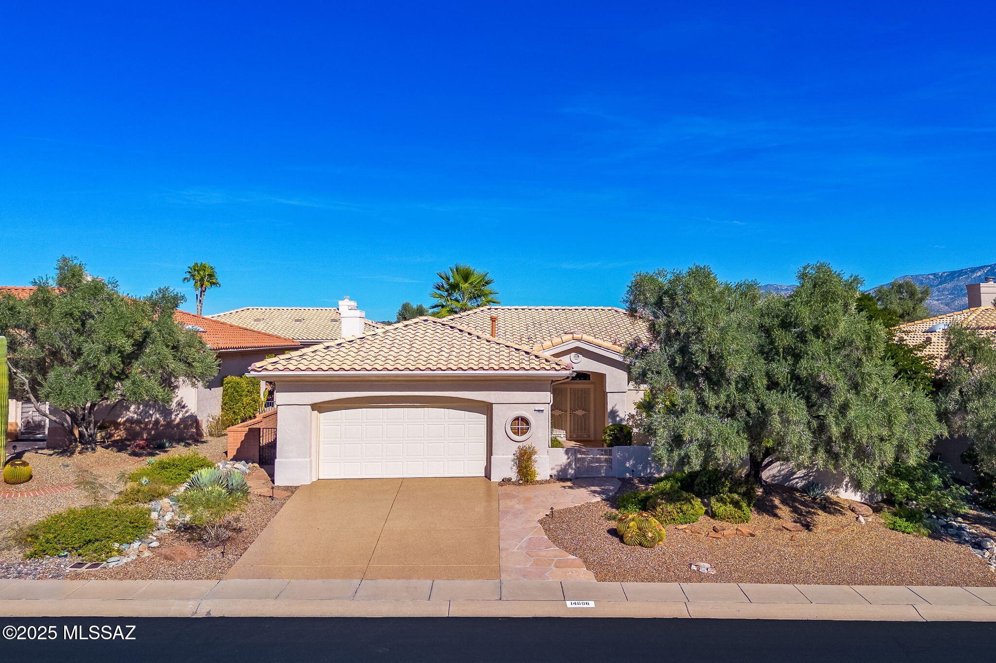 Gorgeous 1,964 SqFt, 2 Bedroom, 2 Bath home with a bonus office area is located in the Premier Active Adult Community, Sun City Vistoso in Oro Valley. From the moment you set eyes on this Impeccably Maintained property you will be delighted by how Spacious, Bright and Beautiful this home is. The flagstone walkway will guide you through the courtyard with mature landscaping, to a glass double door entry with wrought iron security door allowing the fresh air in. Once inside, the foyer welcomes you to an open floor plan that is complimented by soft neutral tones, ceramic tile flooring, high ceilings, and window walls that let in an abundance of natural light and boast gorgeous garden views with an easy flow throughout the home for comfortable living and entertaining guests. The spacious living room offers a separate Dining Area that is perfect for special occasions or enjoying game night with friends. An additional family room adjoins the kitchen and features a stacked stone gas fireplace and is open to a casual dining area, an updated kitchen with granite countertops, SS appliances, electric range, 2 ovens, a breakfast bar, and more... Adjacent to the kitchen is a built in desk and an additional private office space offering a built-in desk with upper cabinets & closet. The oversized two car garage has an epoxy floor, built-in cabinets for storage, a utility sink, access to side yard, and designated space for a washer and dryer.

The Primary Suite boasts beautiful garden views and is appointed with wood grain tile flooring, a double sink vanity, soaking tub, walk-in shower, and a large walk-in closet. The hall bath with tub and shower, accommodates guests and the secondary bedroom, which features two large windows, a ceiling fan, sliding door closet, and carpet. 
If you enjoy gardening and a tranquil space to relax and unwind, you will absolutely fall in love with the meticulously maintained yard, boasting raised flower beds, a pond with waterfall, lush vegetation that provides privacy and the expansive patio that offers shade and accommodates ample seating space for your enjoyment. Welcome home and enjoy all that Sun City Vistoso has to offer!!!

NOTABLE FACTS: Driveway & Garage Floor Coated with Epoxy Sept. 2023; New Interior Paint Throughout 2023; New Carpet Installed in Bedroom & Closets 2024; New Electric Stove; New Refrigerator 2024; New Dishwasher 2024; Roof Replaced 2018; HVAC Replaced 2019; Hot Water Heater Replaced 2019.  Seller did not activate the alarm therefore shall convey As Is.