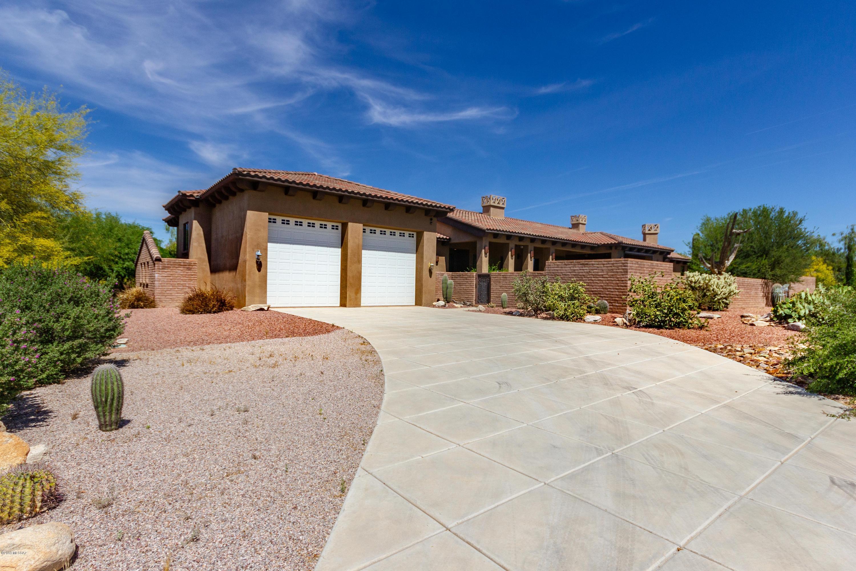OWNER SAYS BRING ME AN OFFER!
OWNER WILL CARRY.
Exceptional CUSTOM BUILT EXECUTIVE home w/RV/Boat Parking near Dove Mtn, 3 Golf Courses, Marana airport, Marana Outlet Mall/I-10. This home has it all! 4BR (2 Master Suites/Den/5BA/LOWER LEVEL PRIVATE GUEST QTRS or THEATRE ROOM or ?? 2-50ft ENCLOSED RV GARAGES (1650sqft) & a 3-CAR-GARAGE. Perfect FOR THE CAR ENTHUSIAST. Gated courtyard & high wall surrounds this home. ENTER into Great room w/soaring coffered ceilings. Chef's dream kitchen w/hand-laid travertine accent tile, oversized granite island that could host large fully-catered events w/ease. 2nd Master suite in PRIVATE WING, gas fireplace & private patio entrance. Resort backyard w/oasis pool/spa area, lush plantings & outdoor kitchen. NO HOA. Master suite showcases an expansive walk-in shower, BainUltra oversized air jetted tub w/ light, sound, hydrotherapy, thermotherapy, chromotherapy, aromatherapy. GRACIOUS master closet has storage for all your needs &  space for seating. Guest bedrooms are in NE wing of the home & are ample size to accommodate king size furniture. End bedroom features private ensuite perfect for long-term guests or family. Spacious OFFICE/DEN has ample working space for 2+ professionals & private surround sound speakers separate from rest of the home. PRIVATE downstairs LEVEL is perfect as 2nd GUEST QUARTERS, game room, or home THEATER. Included private bath, area for bar, popcorn machine, or wine room & two seperate walk-in closets w/possibility of conversion into concealed panic room. Both levels of home have seperate entrances to car & EXPANSIVE DOUBLE RV GARAGE! This home is ideal for oversized vehicles & toys! NO HOA. RV garage is fully equipt w/ all hookups has workshop area, sink, built-in cabinetry, soaring ceilings, built-in space for evaporative cooling. 
Relax, watch the sunset & enjoy the Outdoor Living Room w/built in BBQ, rolling shutters & fireplace. Steps from custom Pebble tec pool. Enough space poolside for cabana if desired... Entire lot has been professionally landscaped/ graded to maximize rainwater w/french drains enhancing the natural desert beauty. Come live the good life... Another Diamond In The Desert!