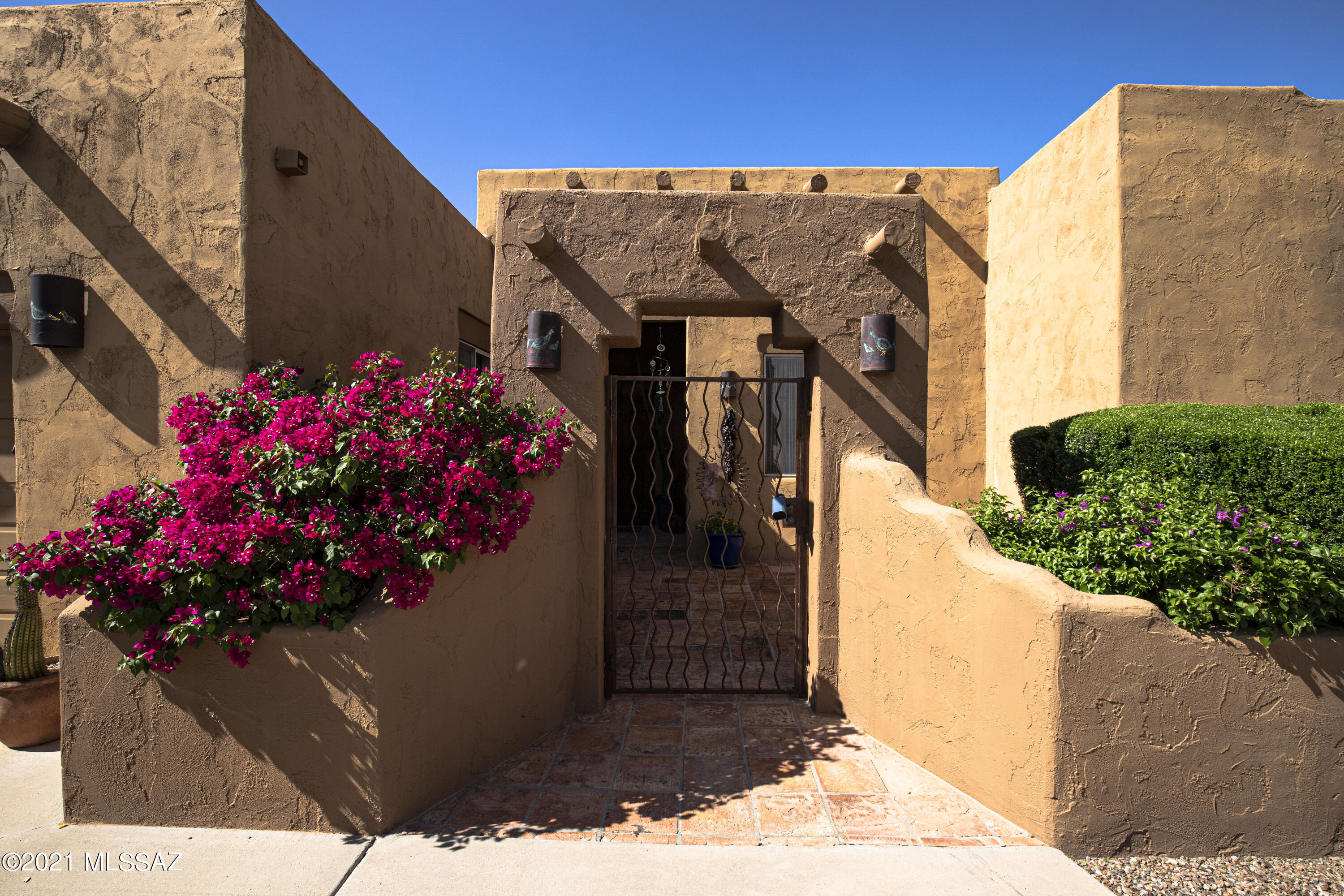 Welcome to La Hacienda. A re-envisioned  Hacienda with a collection of clean, but textured walls, a visual study of its environment, where color, shape, light and shadow help create a mood of peace and tranquility in this professionally designed home. With a wonderful color palate and tranditional-insfused materials, this home's interior promotes relaxation and fun vibes. Once out back, you will find yourself on the huge, resort-style lanai with captivating, unobstructed city and mountain views. Enjoy a cocktail as you watch the monsoons roll across the Tucson sky. You enter this home through a tradition hacienda-style courtyard to find yourself in an architectural delight. Down a captivating hallway to the large, light-filled family room with more amazing views. Then into the gourmet kitchen that is sure to please any chef with a professional Wolf range and high end appliances. Enjoy your morning coffee in the breakfast area with more of the incredible views this home offers. This home surprises and delights around every corner. It is a surprise to see no neighbors from the lanai which offers absolute peace and serenity.