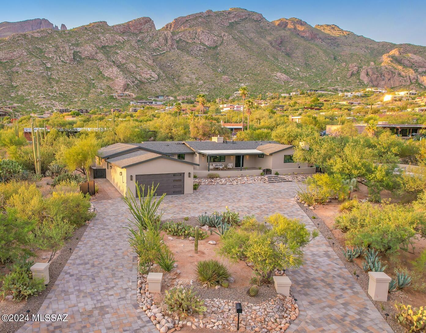 Stunning Foothills Properly w/ Exceptional City & Mountain Views. Incredible Elevated Setting. Comprehensively Re-Designed, Expanded & Renovated.
Luxurious Interiors w/ Modern Farmhouse Flair! Stunning Great Room w/ 10' Exposed Beam Ceilings, Large Gas Fireplace. Stunning Kitchen w/ Thermador Appliances, Maple Slate Cabinets, Quartz Counters, Marble Backsplash & Huge Walk-In Pantry. Split Floorplan w/ 4 Bedrooms + Den. Major Exterior Improvements: 4500 sq ft Belgard Paver Driveway, New Garage, New Rear Patios, New Roof w/ 30-Year Titan Shingles, Extensive Landscaping, Renovated Pool, New Metal Fences, Screens & Gates. Glorious Backyard w/ Outdoor Kitchen & Large Turf Area, All New Windows/Sliders, Electric Upgrade & Gorgeous Dryvit Stucco Exterior. One Owner has AZ Real Estate License.