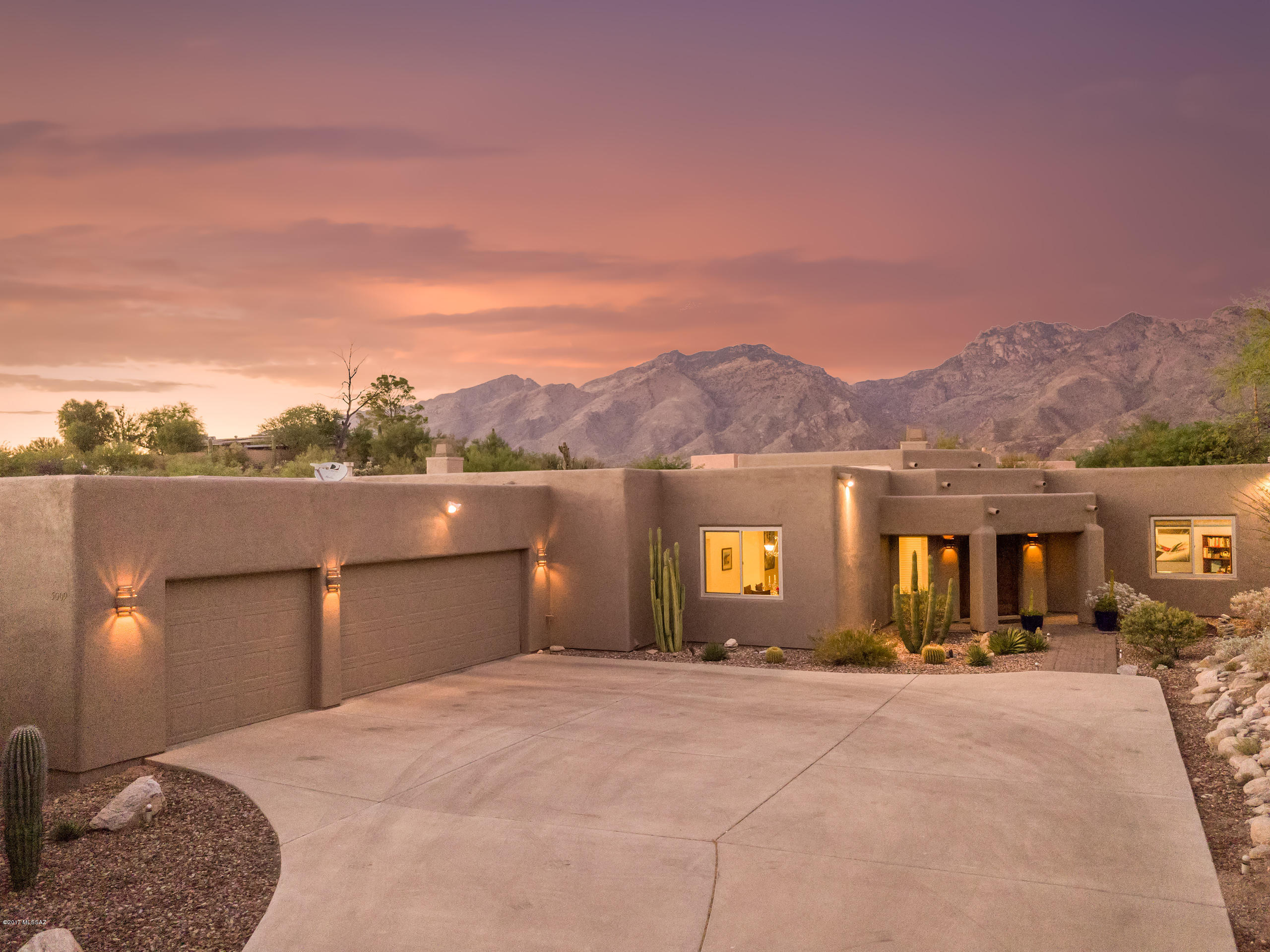 Welcome to resort living in this beautiful contemporary style home in the Catalina Foothills. Gorgeous views of the mountains in a quiet desert setting on an acre lot make this home unique. Walk into an open, airy, split floor plan, gracious rooms with lots of light. Travertine graces the floors, with a gourmet kitchen, granite countertops and maple cabinets. The master bedroom is a paradise in itself with fireplace, large master bath with jetted tub, 2 walk-in closets and Dual-head shower. Facing north this home has oversized windows with views of the Catalina Mountains, pool with fast lane (swimming current) installed, artificial grass lawn and spacious covered patio for entertaining and relaxing. Top ranked District 16, minutes to Sabino Canyon, shopping, restaurants, golf, & more!