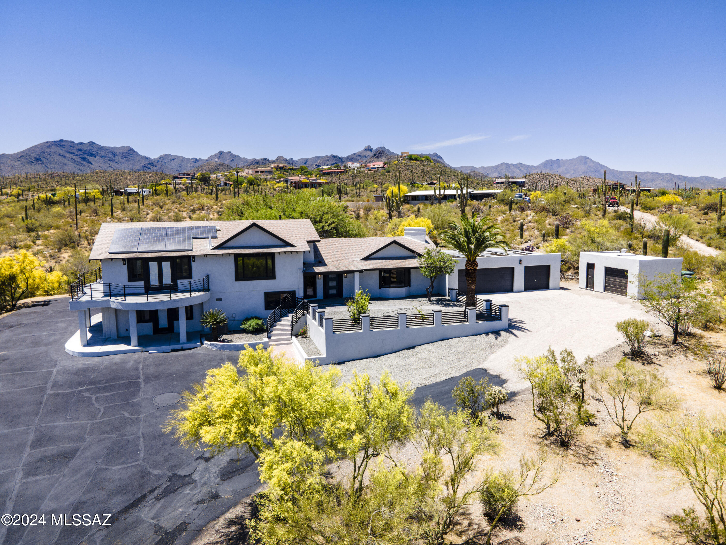Situated high on a gorgeous saguaro-studded 3.57 acre lot, this 100% remodeled residence has commanding views of the city and surrounding mountains. 4 bed - 4bath, 3 car garage plus extra stall to use for parking or workshop..  No HOA! Located at the end of the road, which offers incredible privacy and tranquility. Step into the great room and you will be amazed at the soaring wood beamed ceilings & the stylish fireplace for those festive winter evenings. New gorgeous high-end  kitchen and baths make you feel like you are living in a 5 star resort. All of the cabinetry is in the sleek shaker style with quartz countertops and is the same throughout. No expense spared. The master bed and bath are grand and luxurious, and there is an outdoor deck off the suite with expansive jet-liner views.
