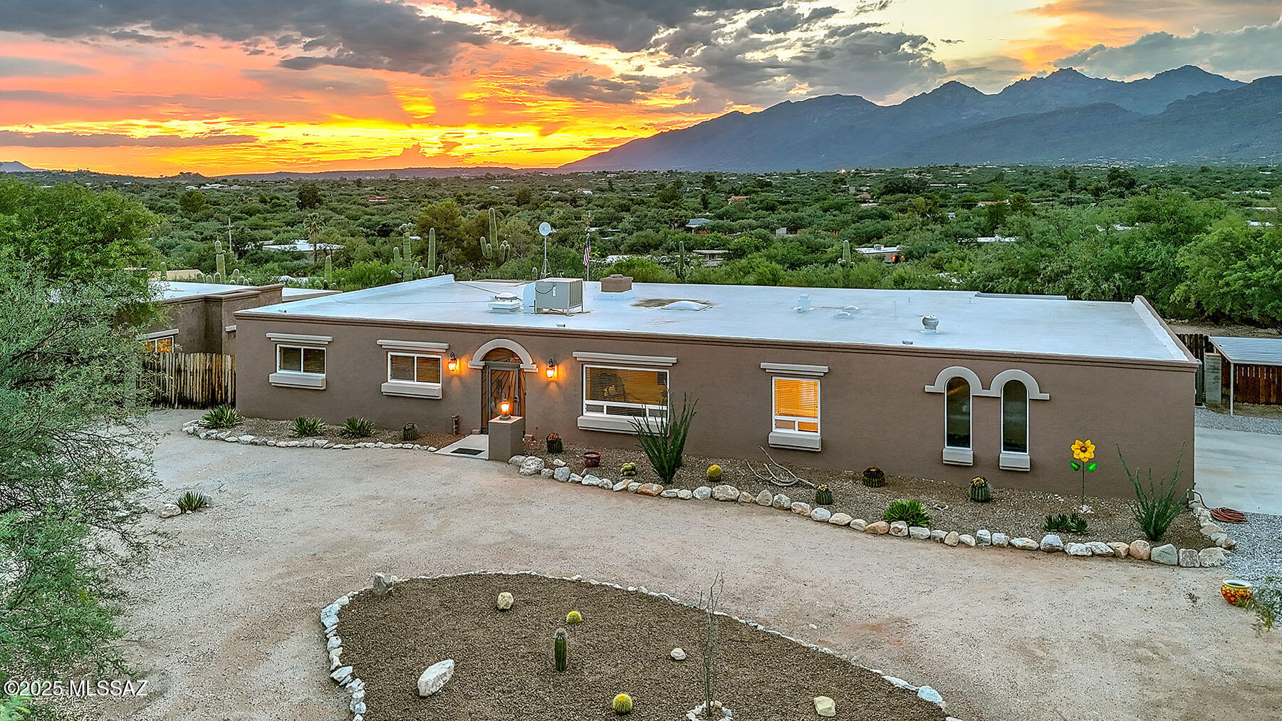 Stunning, private ridge top Southwestern home w/ guest house. The home sits on over 1 acre, with panoramic city, mountain and sunset views. The interior is just as stunning with new kitchen (cabinets, countertops, appliances), new concrete overlay flooring throughout. Ideal multi-generational home: separate guest suite on one end of the home, lovely primary suite on the other. Extended family will love the 2bedroom GH so much they may never leave! Featuring Full kitchen, walk-in closets, full bath and laundry facilities. Lot includes 20+ mature Saguaros! (Full improvement details in documents tab.)