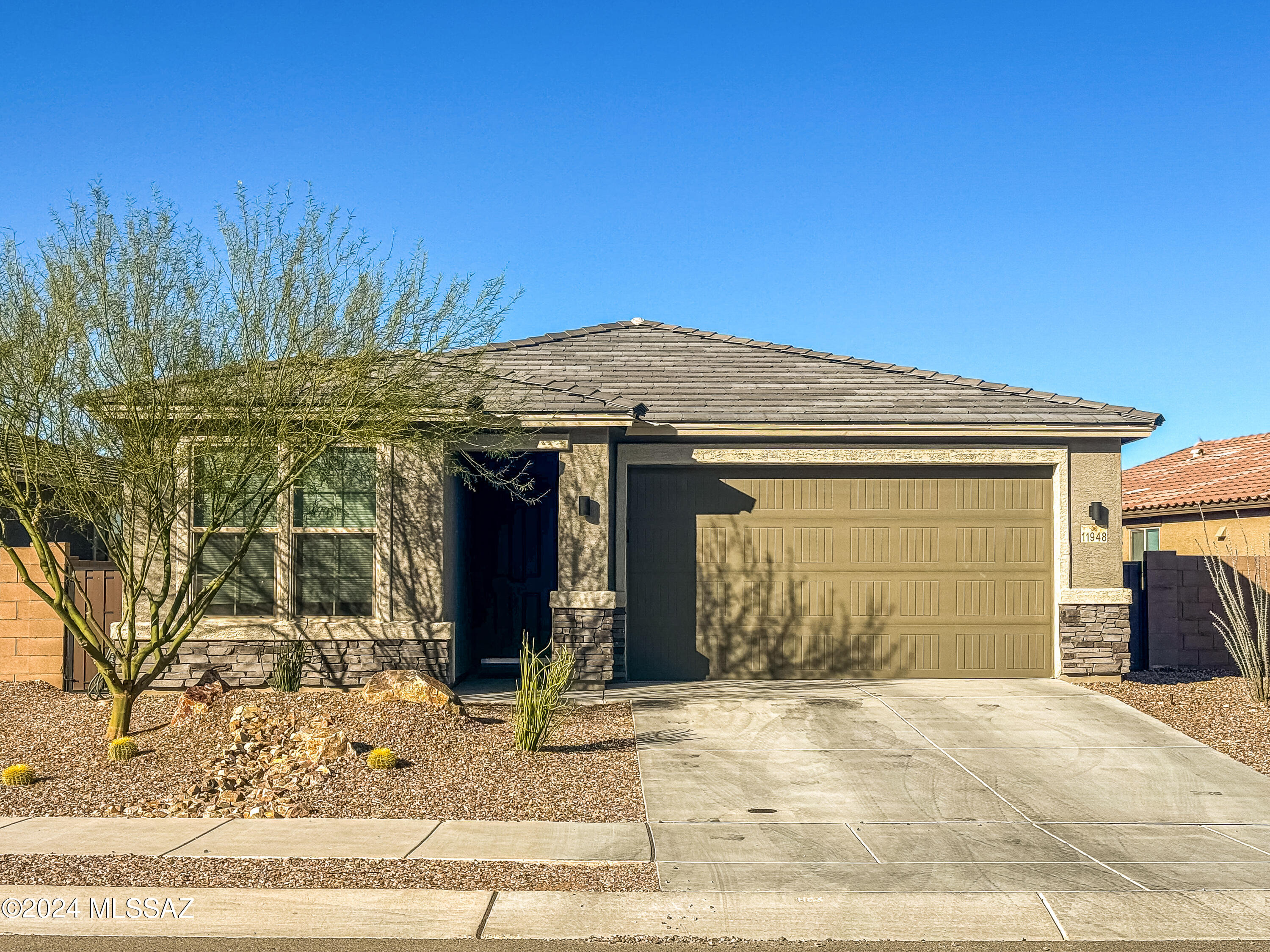 Assumable 2.5% interest rate for eligible VA buyers makes this a killer deal: Turnkey home in perfect location! Minutes from Vail's esteemed schools, shopping, amenities and I-10. Magazine-ready mid-century modern aesthetic coalesces every detail from door hinges, fixtures, designer paint, cellular blinds, soft-close cabinets and Carrera backsplash. Chef's kitchen replete with quartz counters, walk-in pantry, abundant prep space and open concept dining and living areas. Sizeable bedrooms, generous closets and extended garage with wi-fi controls, give everyone ample space & storage. Huge sliders open to gorgeous views from the pristinely landscaped backyard, no neighbors behind and steps from trails and parks make the outdoor spaces complete. Spotless as new construction, but with all the style, projects, and every detail already complete - all it needs is you!