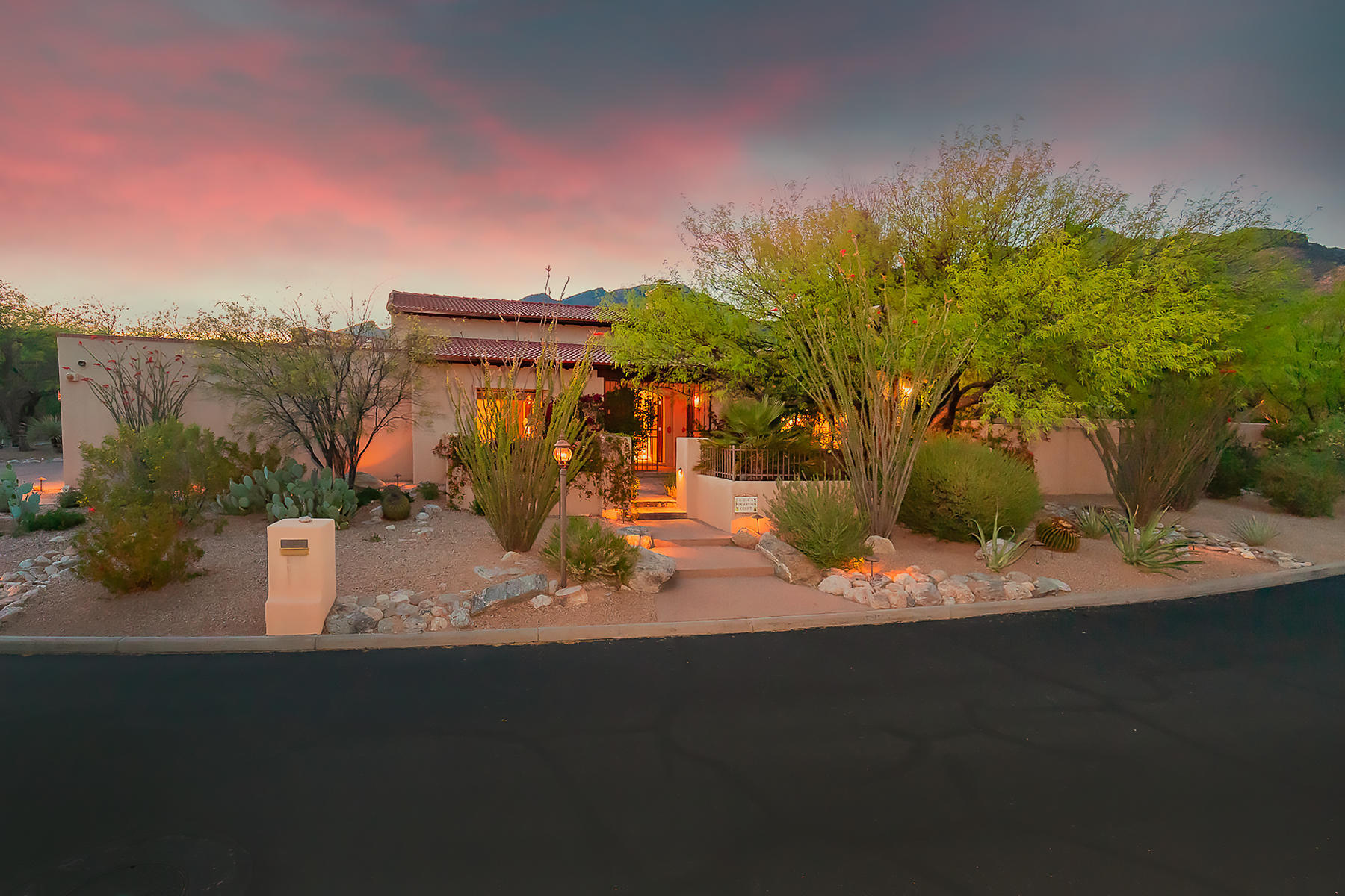 Located in the highly desired gated community of Ventana Canyon Estates on the corner of a quiet cul-de-sac sits this split-plan 3,806-sq. ft. 4 bed/4bath SW contemporary. Enter thru rustic foyer into spacious living room w/ vaulted beamed ceilings & designed w/ craftsmanship, attention to detail, & sophistication at every turn. Chef's kitchen w/ SS appliances & granite counters leads into family room w/ beautiful stacked stone FP & tall windows allowing an abundance of natural light. Large master suite w/ FP, double walk in closet, & access to private covered patio. Entertain guests in serene back yard w/ covered flagstone patio, stunning mountain views, & natural desert landscaping to capture the true essence of the Sonoran Desert.