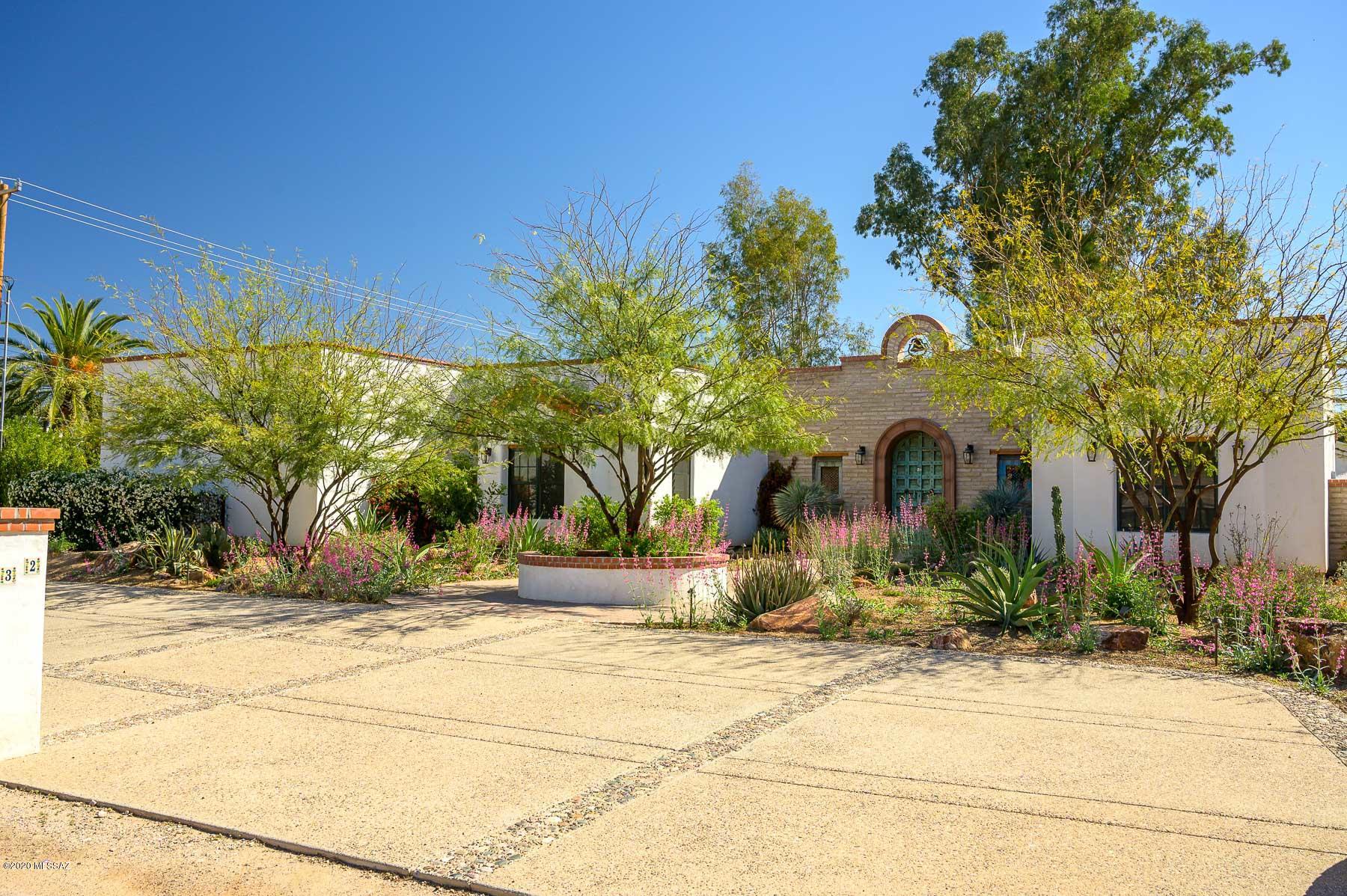 Sophisticated Mexican Colonial Hacienda in historic El Encanto. This Stellar-Gray adobe brick home was built in 2016 and blends the traditional charm of San Miguel de Allende with modern convenience. A walled courtyard entrance leads to a serene koi pond garden. Inside, a vaulted ceiling with hand hewn beams, joins venetian plaster, scored concrete floors, and alder cabinetry and door frames to evoke the Old World. The bright and open gourmet kitchen has colorful custom tile, Wolf stove, Bosch DW and large walk-in pantry. Two master suites and a 3rd bedroom that can be an office. Modern amenities include Marvin energy efficient windows, surround sound, fire suppression system, water softener, and 3-car garage. Elegantly compliant with ADA standards. The casita has a separate entrance. The outdoor area, created by an award-winning landscape designer, provides extensive area for entertaining and relaxing, including a shady ramada, extensive covered porches, Kokomo gas grill, and Pebble Tec lap pool with lagoon entrance and spa, and was part of the 2018 Tucson Botanical Garden Home Tour. A truly enchanting property close to downtown, walking paths, restaurants, and shopping. Don't miss the opportunity to reside in your own Tucson Urban Oasis!