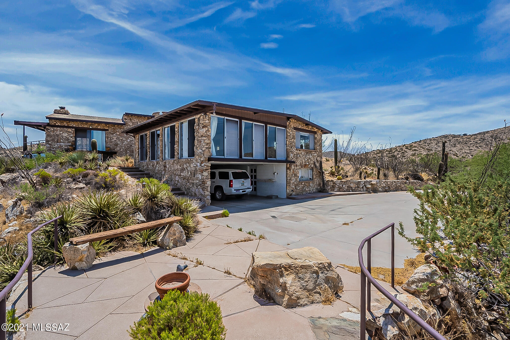 Off grid living in a Unique Stone home built by hand by a master stone mason and his wife. Call for site visit date and time. Do not attempt to access property. Roads are private and road is blocked by locked gates. This estate home and guest house is on the highest isolated peak in the Tortolita Mountains. Outside dining patio and breezeway, living space paired with loft bedroom.  Generator and some solar power.  Multiple viewing windows to capture the wonderful views, elegant double sided open face stone fireplaces. Hickory cabinets, kitchen off great room. Single carport and workshop.  Elegant and artistic touches throughout.  One of a kind Home.  Call for site visit date and time. Do not attempt to access property. Roads are private and road is blocked by locked gates.