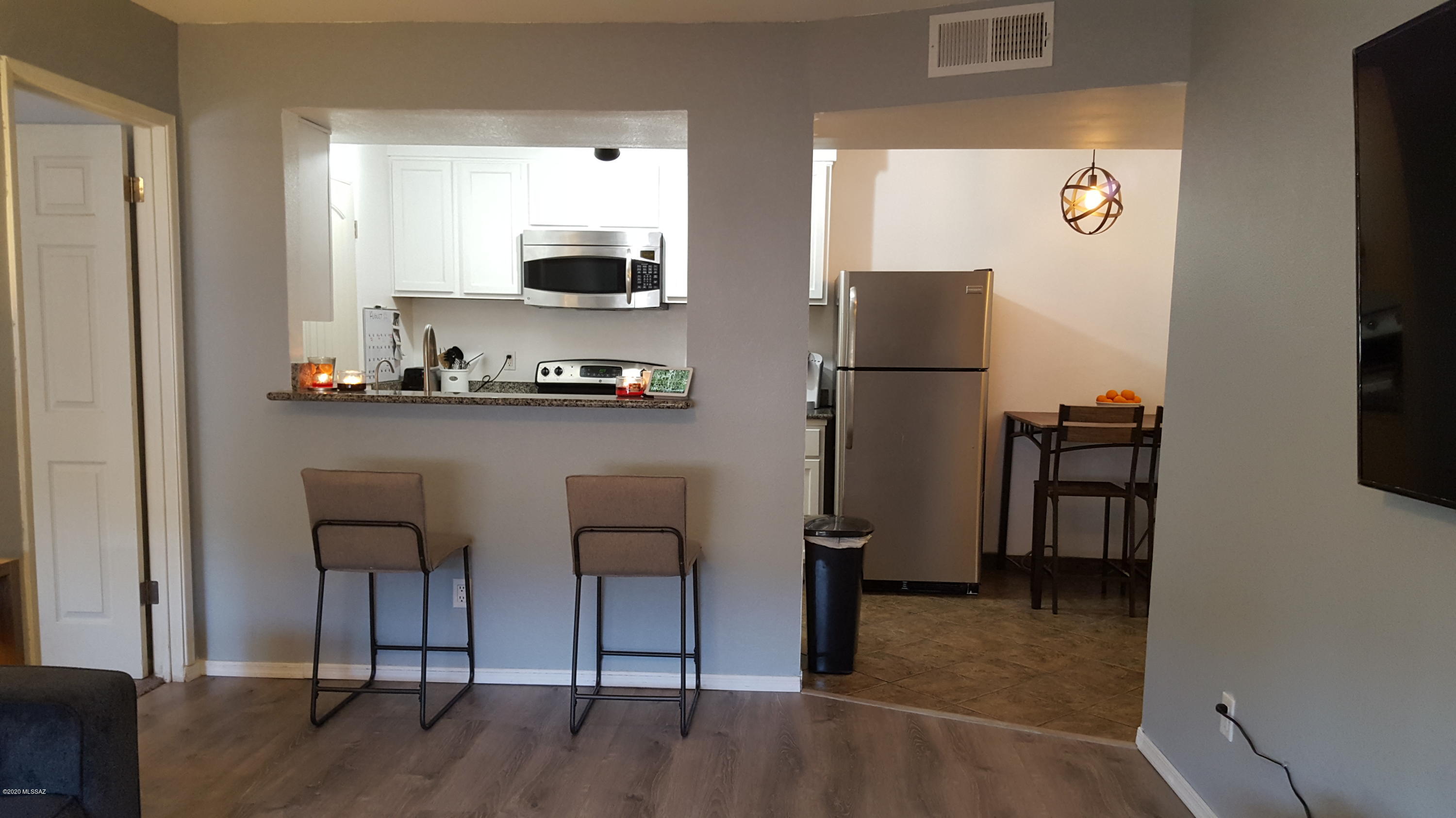 A ground floor unit with many updates. Freshly painted (No Popcorn Ceilings), New waterproof, wood look, vinyl flooring throughout main areas. The kitchen has newly painted cabinets, Granite counters, stainless Steel Appliances, New track lighting and a pass-thru to the living room with a breakfast bar. Bedrooms have lighted ceiling fans, new carpet and each has a walk-in closet. Both bathrooms have newer vanities, ceramic tile in showers and new light fixtures. Quiet community offers a center courtyard with community pool and spa, 3 BBQ grills, umbrella tables and lounge chairs accented by Palm trees and shrubs. 1 Covered parking space with additional uncovered parking on the E & W sides of the community. Some furnishings may be for sale. List available in side unit. Must be purchased on