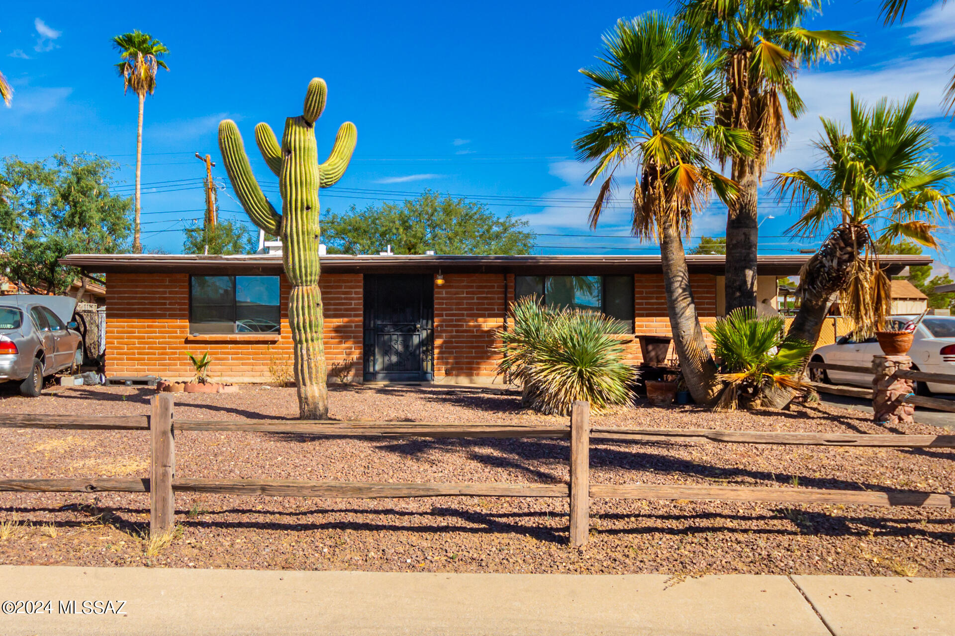 Move into this charming single-level home now on the market! Lovely curb appeal with desert landscaping, palm trees, carport parking, an extended driveway, and an inviting front porch. Discover spacious living areas ideal for welcoming guests, featuring vaulted ceilings, stylish tile flooring, and picture-perfect windows. The eat-in kitchen is equipped with rich wood cabinetry, a tile backsplash, and a skylight. The primary bedroom has wood-style flooring, a private bathroom, and multiple exits. Enjoy memorable BBQs on the paver patio in the large backyard with a detached workshop and storage shed. This gem is full of potential and just needs a little TLC to truly shine! What are you waiting for? Take advantage of the opportunity of this adorable abode!