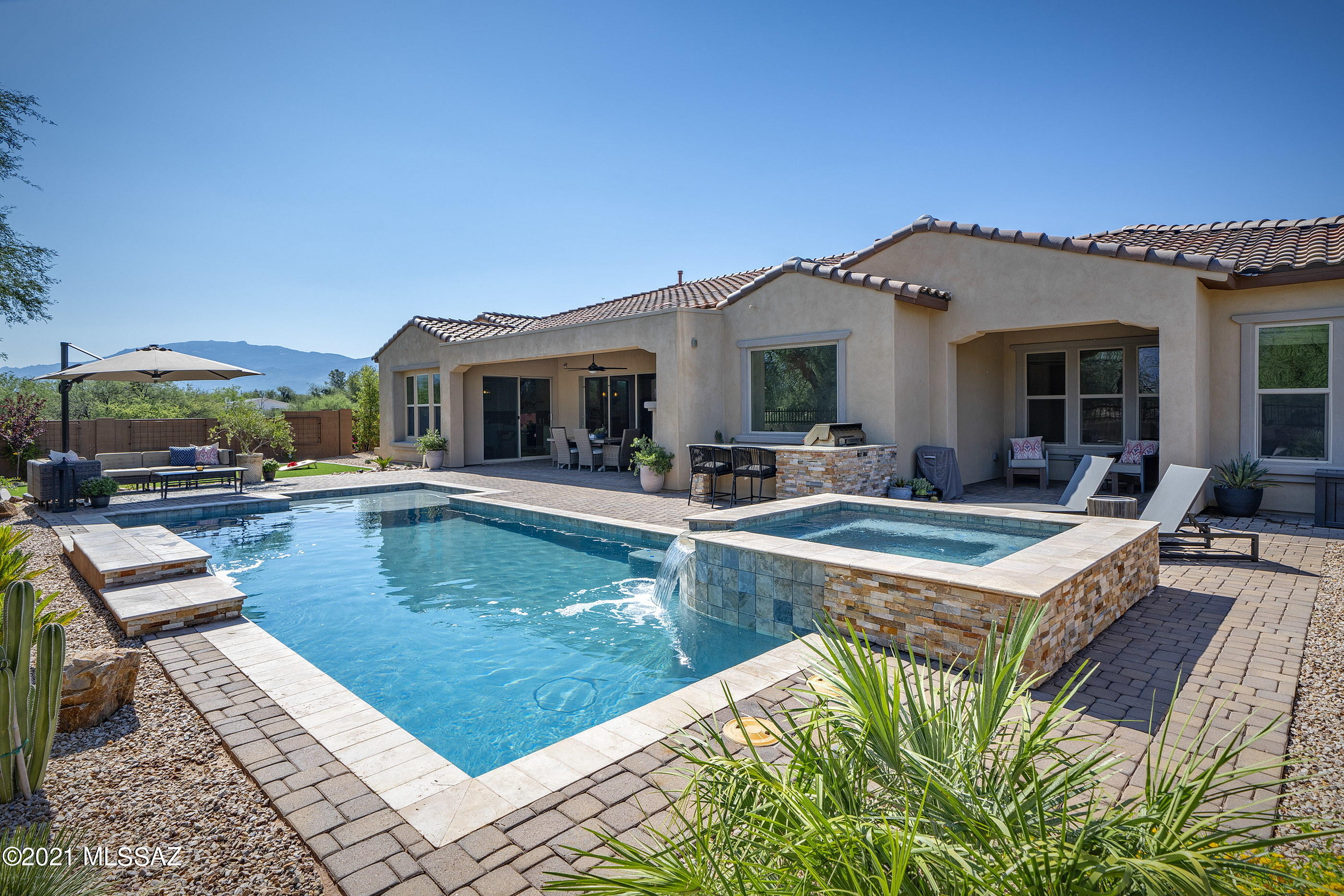 Seller will accept or counter offers between $995,000 - $1,125,000. Spectacular mountain views from this 2016 Pulte built Cul De Sac home in private gated community.  Surrounded by open space w only one neighbor! 4 Bed, 3.5 Bath, 4 Car Garage w Upgraded Electrical, Den & Formal Dining, Kitchen w large island, 2 ovens, large walk-in pantry & large casual dining area. Split bedroom floor plan w separate rec room in the guest wing - great for multi generational living or home office space. Owners suite has an attached retreat w private patio. Beautiful plantation shutters, wired for home audio, water conditioner & softener, RO system and more! Relaxing heated pool w spa is the focal point of this private entertainers back yard w outdoor kitchen, patio fireplace, sitting wall w fire pit, pavered seating areas and synthetic turf. Tanque Verde Schools