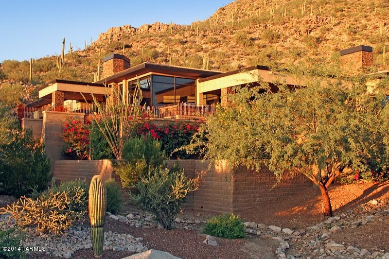Stunning Contemporary nestled against the Tortolitas affords sweeping Golf Course-Mountain-Sunset views! Located in the TERRACE AT SOLANA within the prestigious gated GALLERY at Dove Mountain. Open floor plan highlighted by Natural Stone in main living areas w/carpeted bedrooms. Great Room boasts wall-to-wall Grand View windows and corner stacked stone Fireplace. State-of-the-art Kitchen equipped with Stainless Steel Dacor appliances & Granite counters. Formal Dining Room features an elegant wet bar. Built-in Fireplace and Custom Bath enhance the Master Suite. Office/Den/4th Bedroom. Outdoors you'll enjoy a Solar heated Infinity pool/spa, multiple patios, putting green, fire pit, lush landscaping, and unparalleled views. SELLS TURNKEY & INCLUDES ADJACENT LOT!