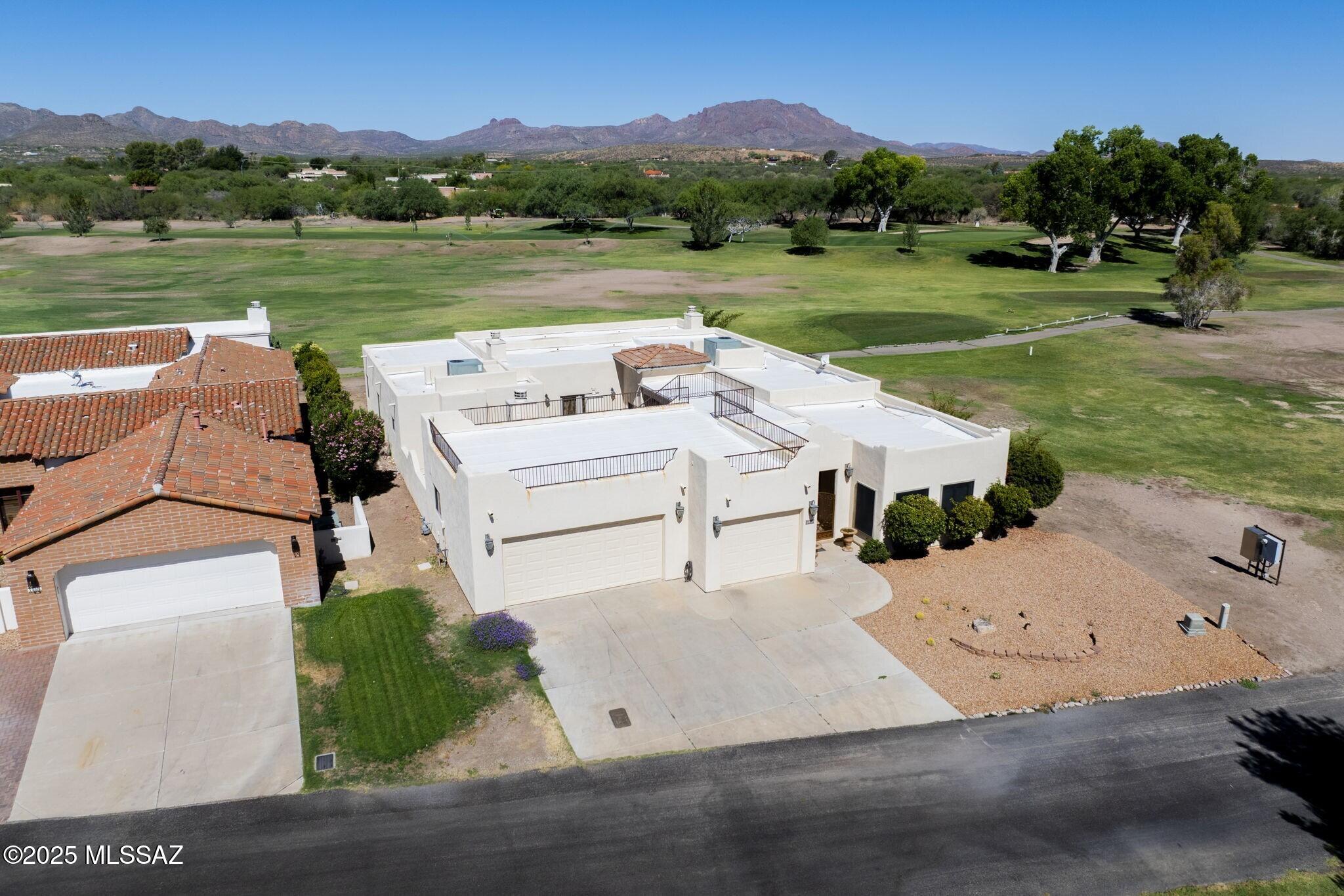 Nestled between Anza 7 and Otero 7 of the Tubac Golf Resort Course, this Tuscan-style home offers privacy and breathtaking views of the Santa Rita and Tumacacori Mountains. Enjoy a screened-in patio, sky deck, and a front courtyard with a fireplace—perfect for entertaining. The 2,200 sq ft layout features 3 bedrooms, 3 full baths, and a 2-car garage plus golf cart bay. A rare blend of timeless style and resort living in the heart of Tubac.