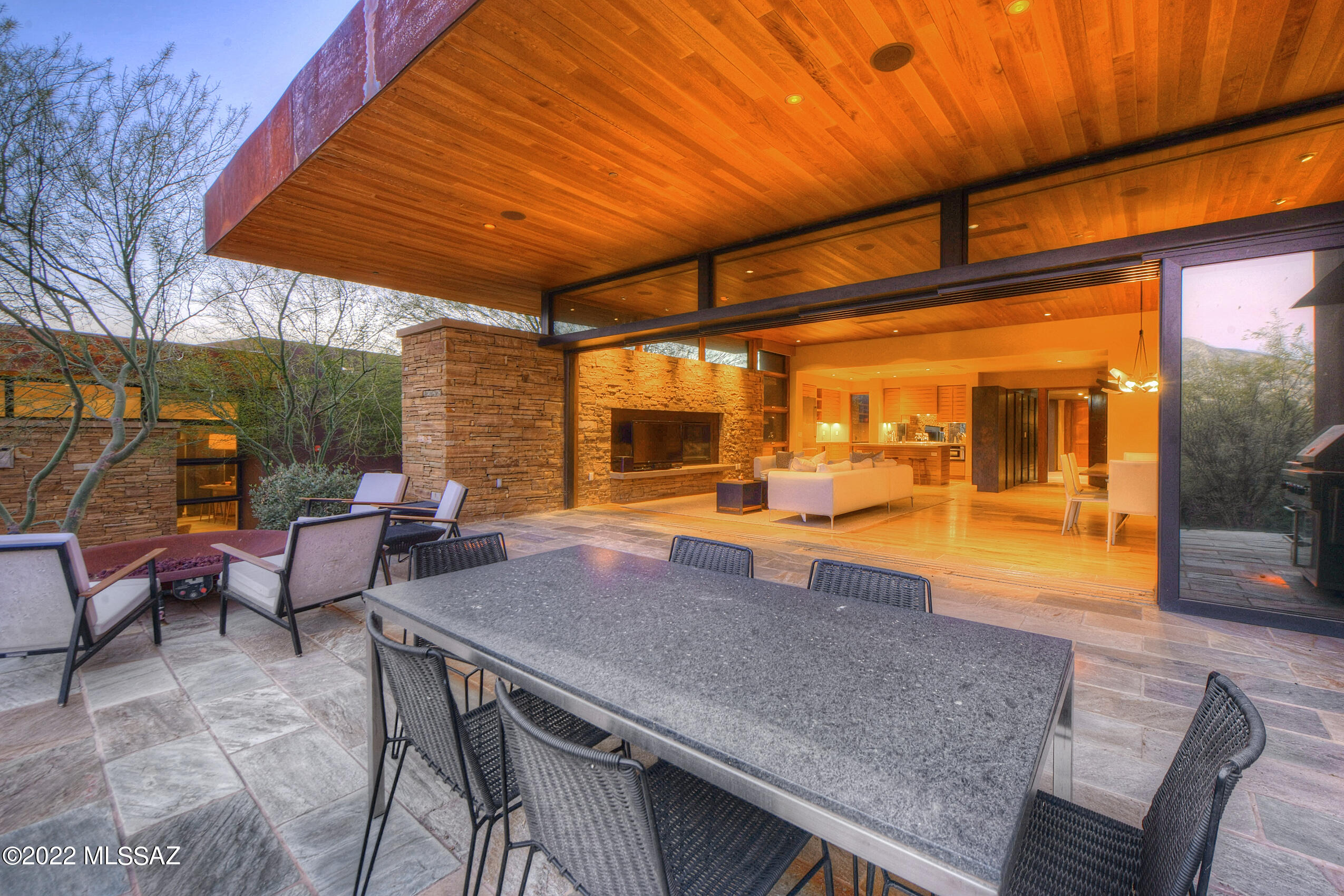 Nature, modern architecture & world-class wellness resort amenities merge to create the rare opportunity to experience serenity & rejuvenation in the Sonoran Desert at Miraval Arizona.  Seamless design w/ timeless, high-quality materials that allow the surrounding natural beauty to take center stage.   Designed by Seattle architects, Mithun, this exquisite Villa located on the grounds of the Miraval Arizona wellness resort & spa delivers a next-level residence w/ property management, concierge service, housekeeping & resort access. Situated on the slopes of Tucson's Catalina Mountains, this home-site offers unparalleled views & privacy.  Constructed w/ a blend of rammed earth, glass, metal, wood, concrete & stacked stone, this Villa meets the  high standards of sustainability & efficiency required to receive a LEED Silver rating. This single-level home is designed for privacy & comfort when entertaining family & friends w/ a main house & a separate guest house protected by an inviting courtyard w/ desert plantings & fountain.  The main house features a gourmet kitchen w/ concrete countertops & center island w/ breakfast bar that opens to a great room w/ a stacked stone fireplace & spacious dining area.  Massive retractable glass wall opens to provide effortless indoor/outdoor living & dining.  The east-facing patio w/ a gas fire feature has unobstructed mountain views & magical sunrises to start the day. Owner's suite w/ gas fireplace, spa on deep private patio w/ built-in seating, walk-in closet w/ custom built-ins & spa inspired bathroom w/ large indoor shower, dual sink vanity w/ concrete countertops & a phenomenal outdoor shower. Guest house w/ en-suite bedroom w/luxurious bathroom w/ separate shower, soaking tub & outdoor spa.  Additional room could be office or 3rd bedroom.  Miraval resort offers a variety of unique experiences that include equine therapy, zip lines, ropes course, hiking, biking, yoga & much more.  A range of spa services & excellent organic food choices available.  This property is also an investment property with resort managed rental program that can be utilized when the owner is not using the Villa.