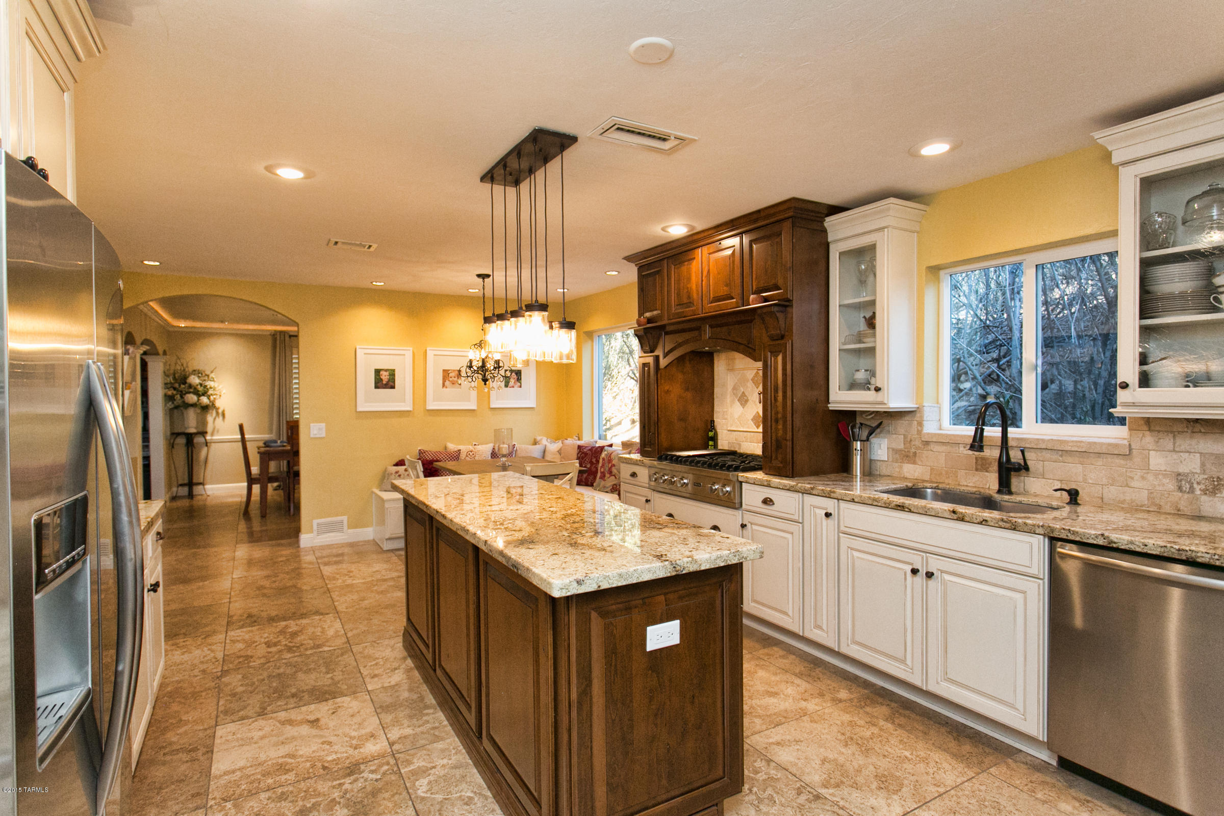 Experience the old world charm from the moment you drive up the cobblestone driveway. This remodeled home features an open floor plan. Great room highlights travertine flooring, a lime stone fireplace, handsome beamed ceiling and large picturesque windows with stunning city views. Designer kitchen features Viking appliances, top grade cabinetry, slab granite counter-top, gorgeous lighting and custom designed breakfast nook. First floor master suite features a luxurious spa bath and large walk-in closets.4 bedroom+theatre room+ office are located on separate level. Enjoy city,golf course, and colorful sunset view off second floor balcony. Country club on site provides golf, tennis, fitness facilities and pool; activities for a healthy lifestyle.This retreat is ideal for friends and family.