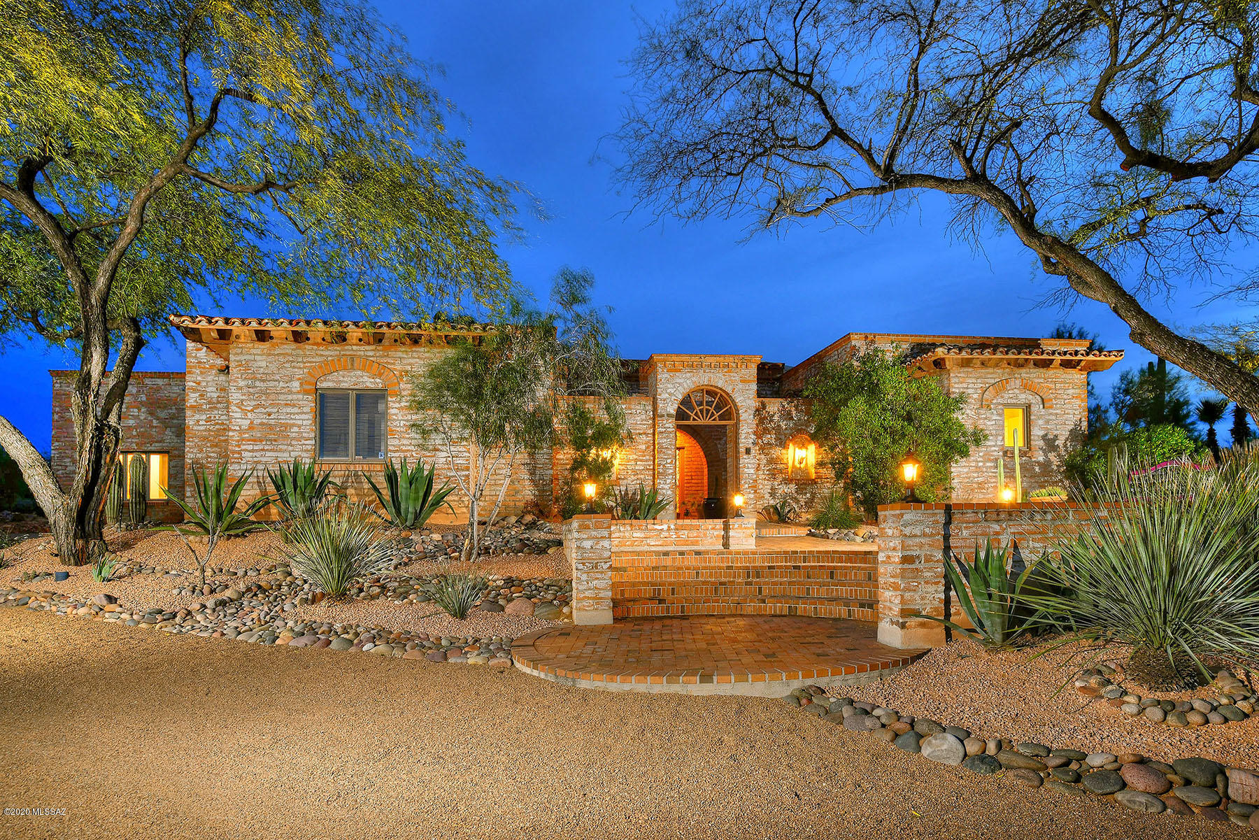 Classic adobe brick construction with extensive outdoor patios & interior courtyard accessed by windows & doors to the fabulous exterior.  Inside you're greeted by soaring wood beamed ceilings vaulted above an open floor plan with a circular fireplace, wall of windows & arched doorways.  4 bds in a split plan, each w/ their own en-suite bath, truly beautiful master w/fireplace, beamed ceilings, mountain views, office nook, & exterior access to courtyard w/firepit & jacuzzi.  Attached gst quarters boasts it's own living rm w/fp (or family rm). Energy Efficient as property served by brand new PURCHASED SOLAR (very minimal electric bills).  Resort-like pool, built-in bbq, beautifully landscaped w/ extensive use of brick pavers & flagstone.  See DOCUMENTS tab for more info- REALLY SPECIAL!
