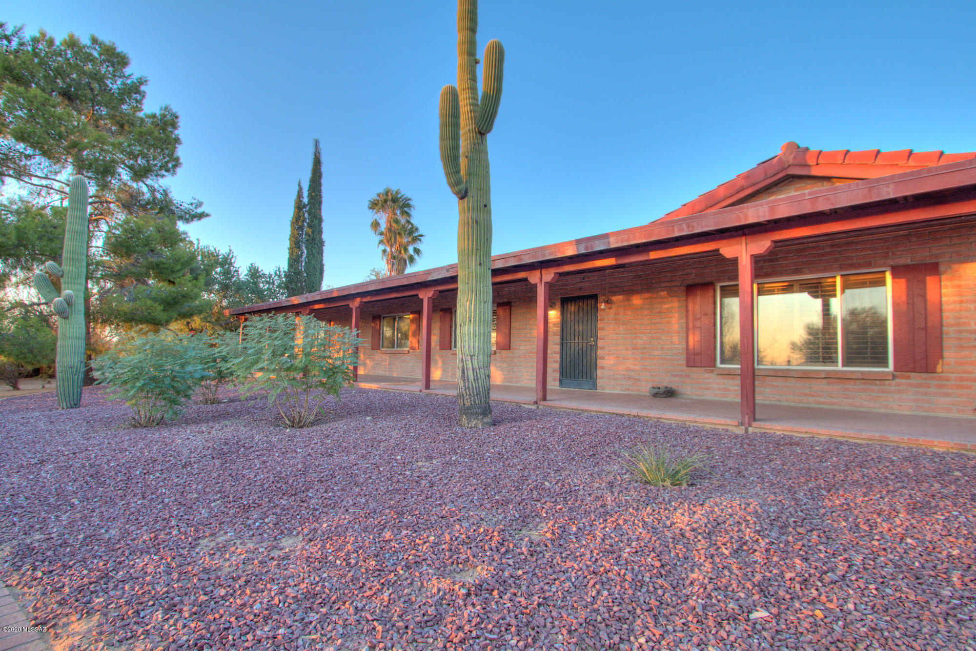 If you love horses, this property is everything you've been looking for! With sprawling mountain views and true southwestern charm, this 13.5 acre ranch in NW Tucson has it all! The property features a stunning burnt adobe ranch house with open beamed wooden ceilings, exposed brick walls, multiple fireplaces, classic Saltillo tile, and a lovely gated pool and Sonoran desert landscaping. The matching guesthouse is truly unique! This property features a 350 foot by 140 foot roping arena, a six stall barn, multiple corrals, a round pen, a spacious chicken coop, a workshop, a private well and a 3 car garage! A functional ranch with gorgeous mountain views, a stunning home, and an amazing location is hard to find. Don't miss it! Check out the video & 3D tours online. Sale includes 2 parcels.