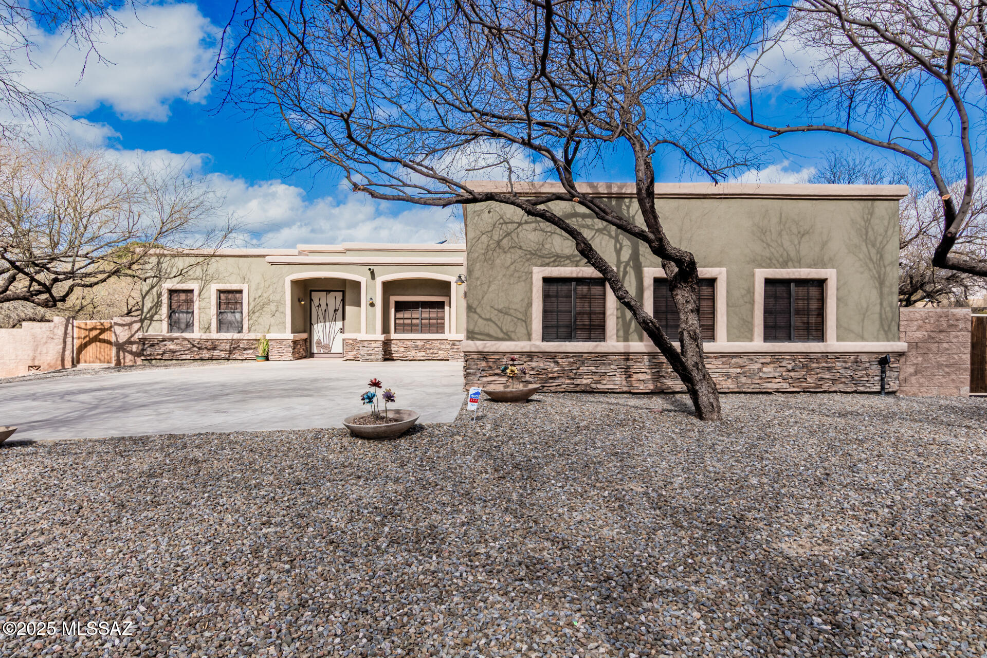 Welcome to this beautiful home in the Forty-Niners Country Club. Sitting on .9 acres, this 4-bedroom, 3-bathroom home offers polished concrete floors, a split-bedroom floor plan, and an updated gourmet kitchen with a walk-in pantry, wine fridge, and spacious laundry room. The backyard is built for entertaining with a covered patio, BBQ island, fire pit with built-in benches, pool with spa, garden area, and a fenced pet space. A large RV/boat gate provides extra storage. The primary suite includes a flex space for an office or gym, a walk-in shower, and a jetted tub. A bathroom is accessible from the pool, while two bedrooms share a Jack and Jill bath. The oversized garage spans 1,000 sq. ft. with 8' doors and a 25' depth, perfect for trucks and storage. Paid-off solar keeps utility costs low. Located in the Tanque Verde School District, this home blends comfort, function, and style. Don't miss this incredible opportunity.