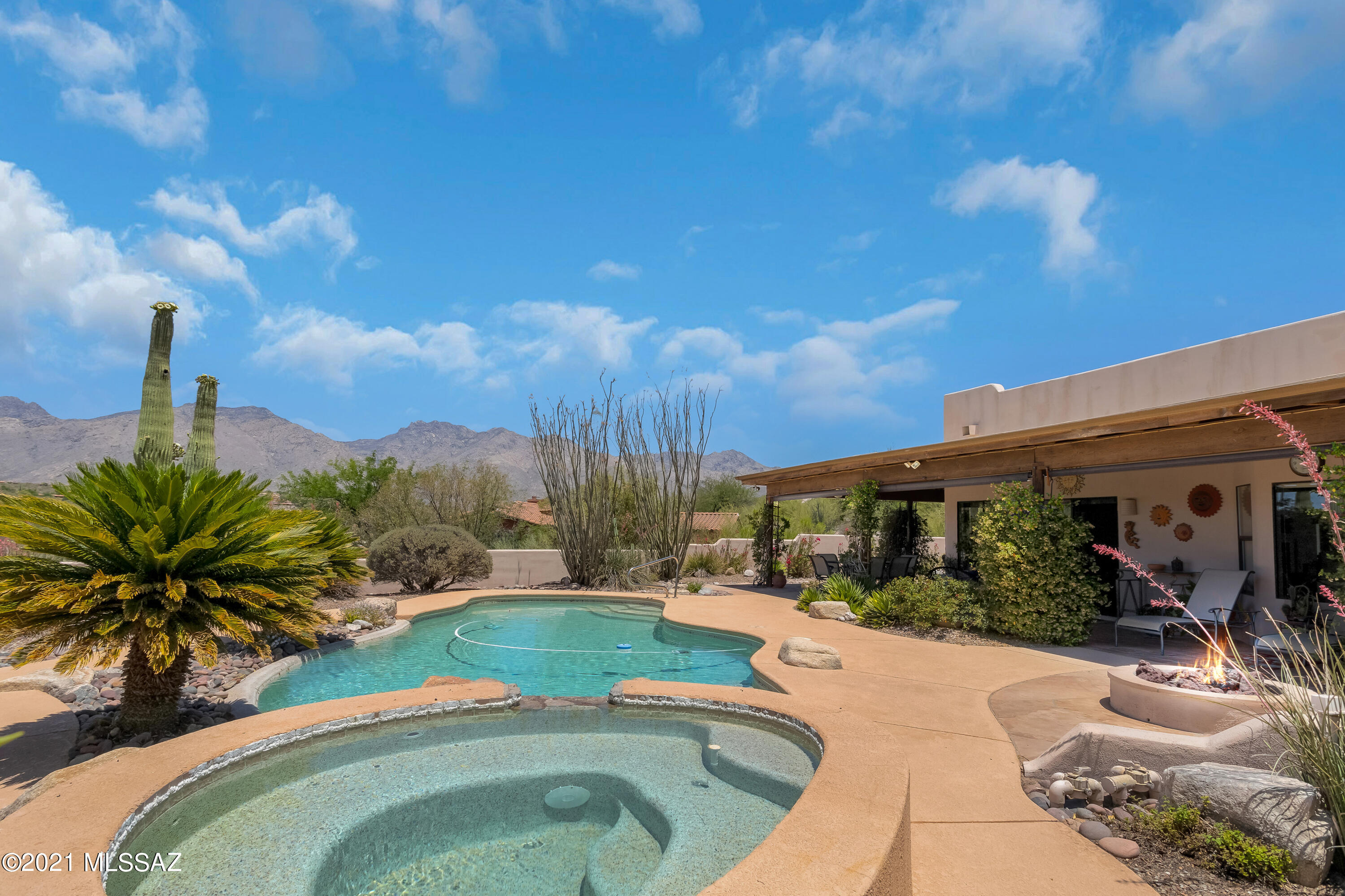 Custom Southwestern style Ridgetop home bordering acres of common area w/majestic Catalina Mtn views in Fairfield. Interior features 4BR/3BA, saltillo tile & carpet, soaring viga beam ceilings, beehive FP in family room & a fireplace in Living Room. Spacious updated kitchen has quartz counters, alderwood cabinets & SS appliances & opens to Family room. Huge picture windows in both Living room & Family room look out to our beautiful mtns. The lush backyard offers wrap around covered patio, sparkling pebble tec pool & spa, fire pit & gas BBQ hookup for outdoor entertaining at its finest. 
Come live the good life!  All poly pipes and water heater just replaced 7/21.