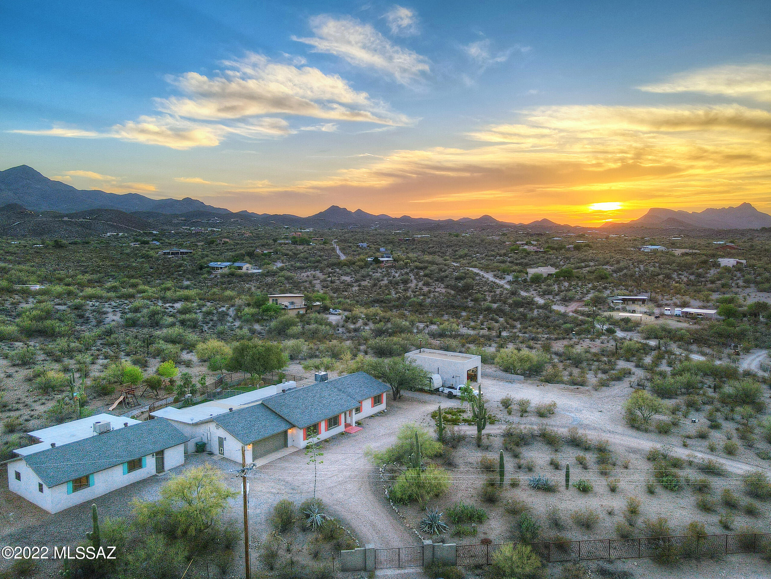 Live in true privacy & seclusion without the restrictions on an elevated 3.89 acre gated compound in the foothills of the Tucson Mountains. Plenty of room for RV's, boats, ATV's or horses. Just minutes from I-10, shopping, restaurants & more, this dream property has it all: 4 bdrm/4 ba completely renovated & move-in ready main house w/ split bedroom floor plan, 4 garage spaces, big backyard w/ deep covered patio, fenced pool & low-care artificial turf; 1535 sf completely renovated separate guest house w/ 2 bdrms/1 ba, full kitchen, laundry room & private covered patio, currently used as an Air BnB that produces income; 818 sf 20 x 40 ft workshop w/ 100 amp service, large automatic roll up doors on both sides, mini-split for temperature control & much more! CONT.