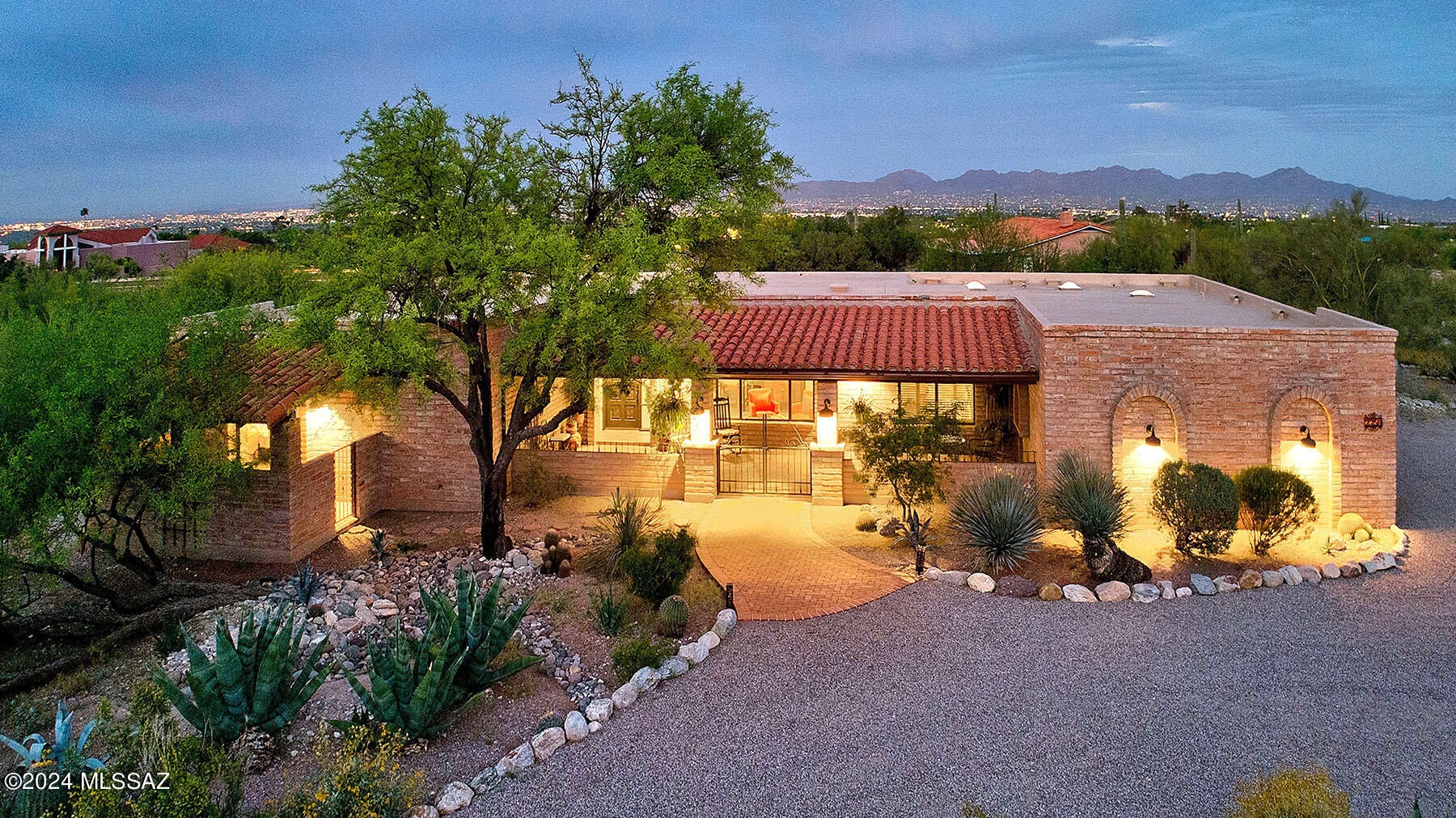 Welcome to this gorgeous desert oasis nestled in the upper foothills featuring a stunning territorial home with the perfect blend of charm and modern luxury.  The large front patio, ideal for savoring mountain views, leads you inside to the foyer where you immediately appreciate the lovely tile floors throughout and the expansive living and dining rooms accented with beautiful arches.  Sleek remodeled kitchen boasts modern amenities and ample space, while the adjacent family room features exposed wood beam ceilings and cozy FP.   Retreat to the huge primary suite w/dual sinks, lg W/I shower & generous W/I closet. Enjoy the beauty of the desert landscape from the lg back patio, extended w/pavers for outdoor entertaining. Complete w/3-car gar, this home embodies desert living at its finest.