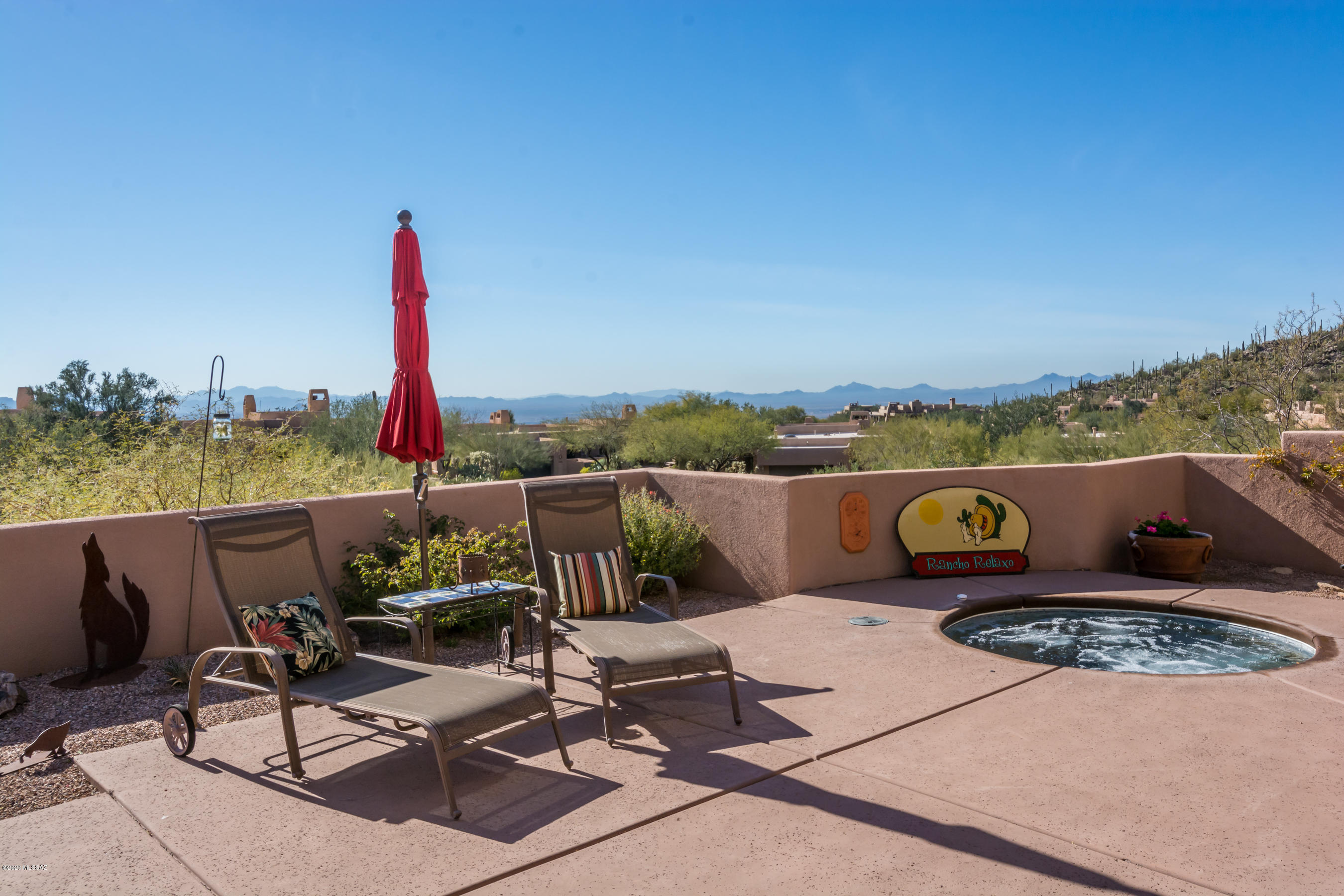 Golf is ''ESSENTIAL'' in Dove Mountain ! This Gallery Cottage is nestled in the Tortolita mtns.  Stunning sunset views from this expanded floorplan.  Planked & beamed ceiling in Greatroom/Dining w/ gas FP w/ raised hearth.  Roomy kitchen w/granite island bar top seating, gas cooktop, built in oven & micro, desk area, display cabs, nook area. Laundry offers W/D, sink, cabs, counter. Master suite-a true oasis:  corner gas fireplace w/ room for chairs, rear patio access, dual custom closets, jetted tub, dual vanity, large shower. Guest suite gives guests it all: en suite bath, walk in closet, gated front patio access! Third BR can be office or guest space w/ Murphy bed! Hall bath has large shower.  Bubbling in ground spa, built in BBQ, gas FRPL accent this lovely view patio. 2 car garage.