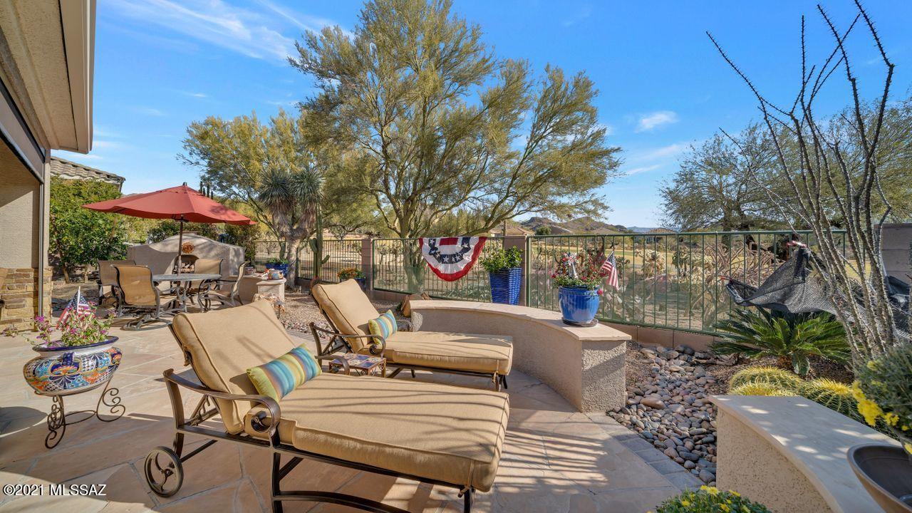 BREATHTAKING Catalina Mtns & golf course views (3rd fairway) with this PORTLAND Model! Gated courtyard welcomes you! Foyer opens to formal dining area, great room & kitchen. Den has antique double glass paned doors. Great room has gas FP, lighted display niches, wall of windows. Neutral granite w/plenty of cab space. NEW GE appl. Extended LRG laundry w cabs, sink, desk/craft area. New, remote controlled screened patio w/ TV, blt in BBQ, cozy gas FP, new landscaping front & rear. Roomy master offers patio access, bay window, 2 closets, sep vanities, spacious shower w/ bench. Guest room & hall bath. Extended garage w/ sink, cabs. Exterior accented w/ stacked stone.  Extensive upgrades & improvements (see attached list) gives you a ready to move in home in The Highlands!