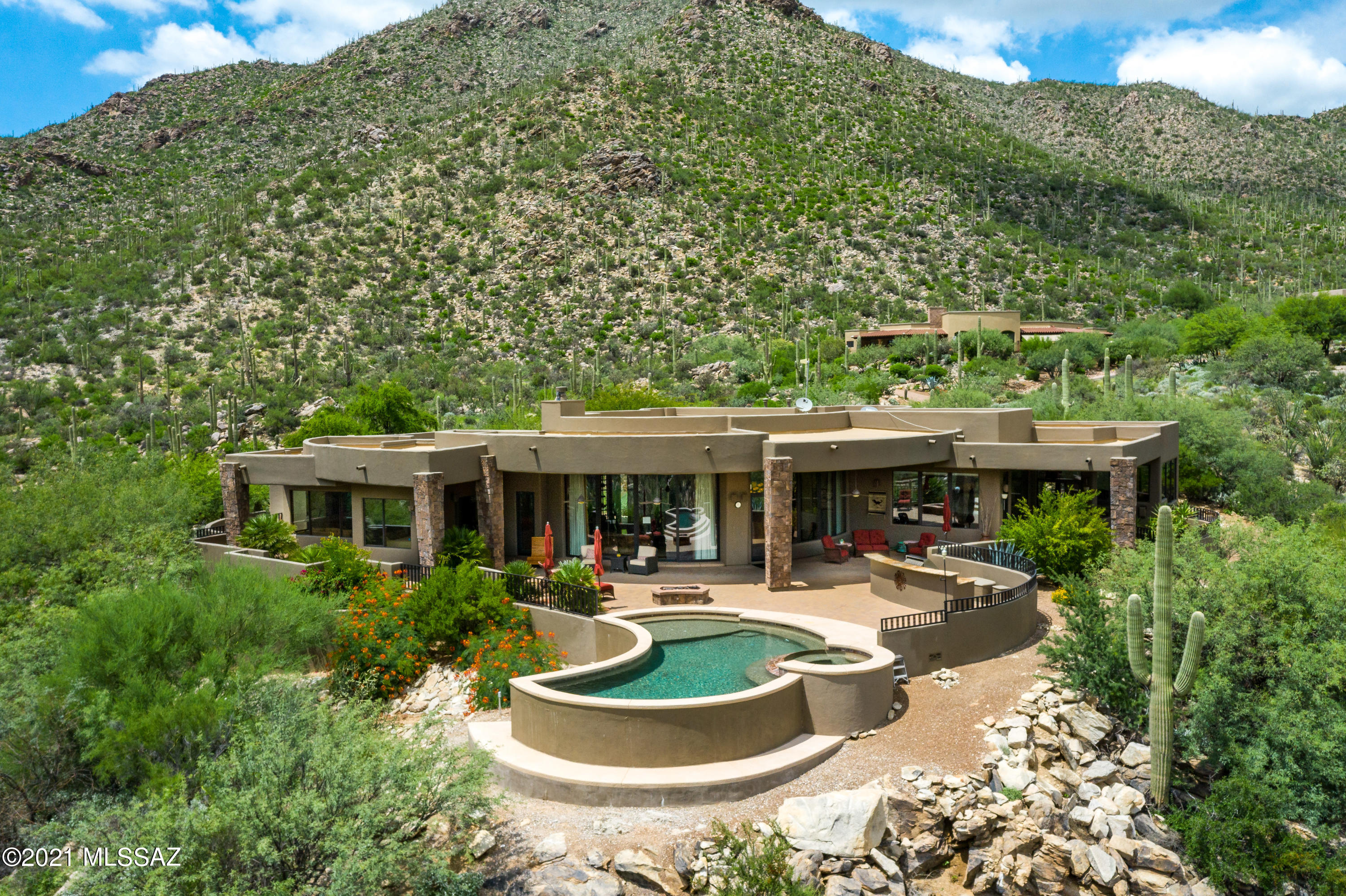 Extremely Private Canyon Pass Home in the Saguaro Studded Tortolita Mountains with Stunning Panoramic Views. Chef's Kitchen with Gorgeous Slab Granite Counters, Wolf Stainless Appliances, 48'' Gas Range Cooktop, Double Ovens, Walk-in Pantry with Custom Built-ins, Custom Tiled Backsplash, Center Island & Sunny Breakfast Nook. Open Great Room with Travertine Floors, Custom Fireplace & Wall of Windows Capturing the Views. Dining Area for Entertaining. Primary Suite with Romantic Fireplace & Walk-in Closet. Elegant Primary Bath with Jetted Spa Tub, Double Vanities & Custom Tiled Walk-in Shower. Media Room, Den& 3 Bedrooms. Huge Laundry Room with Cabinets. Resort Quality Outdoor Living Space with PebbleTec Pool & Spa, Expansive Brick Paver Patio, Shady Covered Porch, Built-in BBQ Grill& Firepit