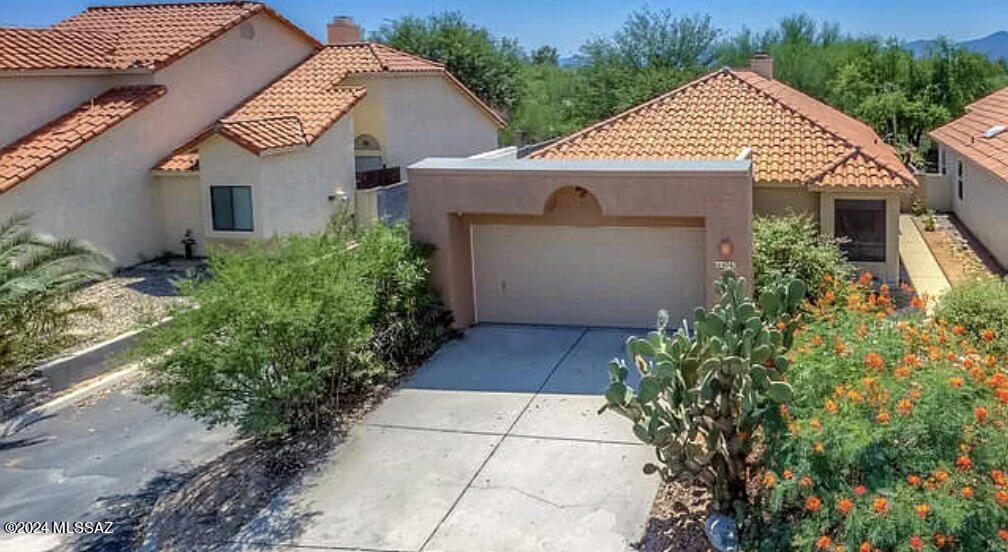 Discover your dream home in this stunning gated community. This beautiful residence features an updated kitchen with a generous pantry, perfect for all your culinary needs. This home boasts updated plumbing, free from polybutylene pipes. The large primary bedroom offers a newly remodeled roll in shower, a spacious walk in closet and dual vanity sinks. Enjoy the cozy ambiance of a two way fireplace, complimented by attractive Saltillo tile that adds warmth and character to the Great room. High ceilings enhance the spacious feel of the living space, creating an open and airy atmosphere. Step inside to the large peaceful screened-in patio. where you can gaze out onto a serene backyard that opens to a natural desert landscape. Relax in almost new hot tub as you unwind in your private oasis. The seller has spent over $12,000 on bathroom remodel and upgrades. The seller has also spent over $12,000 for installation of a new hot tub, electrical and slab.