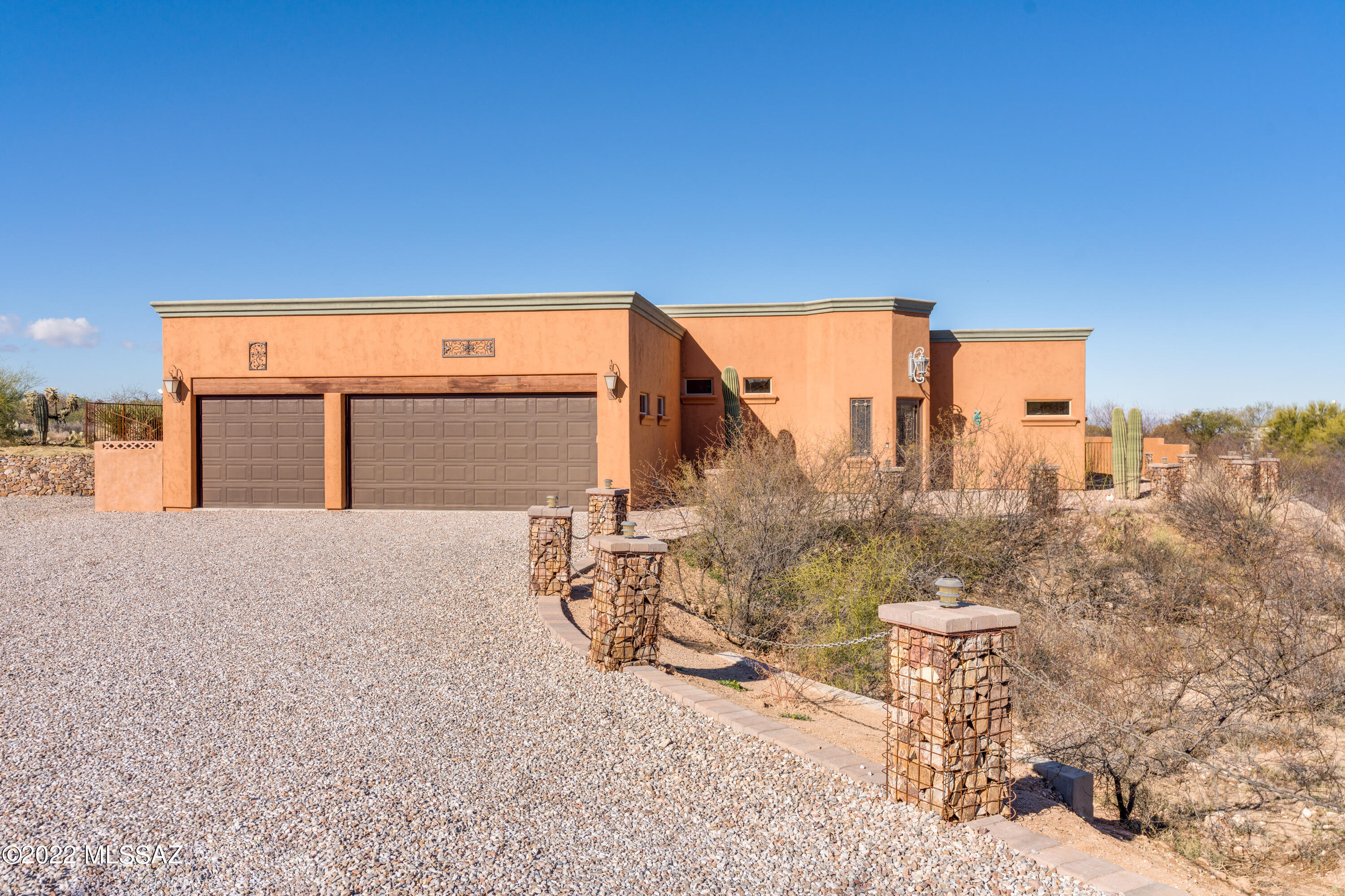 Open House Saturday 2/26 from 2-5pm. Amazing Custom Vail home with 2789 sq.ft. 4 bedrooms and 2.5 bathrooms.  Designer touches throughout the home; Blown glass light fixtures, curved ceilings, Wrought iron and glass insulated front and back doors, solid alder cabinetry and doors throughout, floor to ceiling tile in bathrooms, oversized 3 car garage, built in display cabinet with barn doors in the dining room, walk-in pantry, concrete floors throughout, double master closets and a heated and cooled dog spa room...It might be hard to pick your favorite feature. This home sits on 1.08 acres in a small community heading towards the Rincon mountains. Tranquil large fenced backyard with fire pit, and several seating areas, or get your hands dirty in the greenhouse! Don't let this one get away!