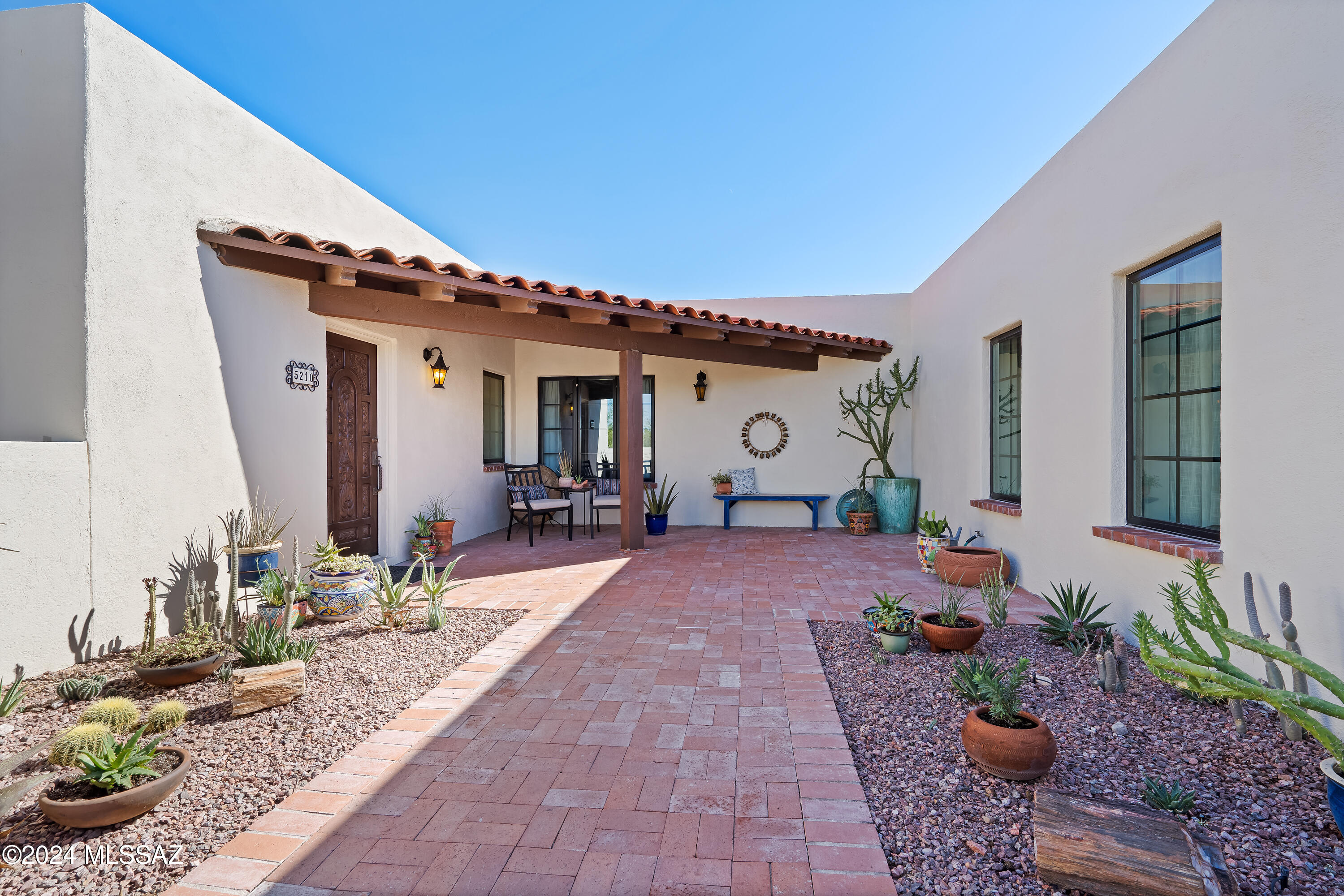 Oriented delightfully on a corner lot in Catalina Foothills Estates number 7, this stunningly updated home offers both mountain and city views.  With a split bedroom floorplan, sprawling custom kitchen, and multiple extraordinary outdoor spaces this home is a turnkey dream. Timeless details such as a gas fireplace and wood beamed doorways, couple beautifully with alder interior doors, stained concrete floors, and all new windows and patio doors throughout. Enjoy District 16 schools, a 2 car garage, and breathtaking city lights from the expansive back patios.