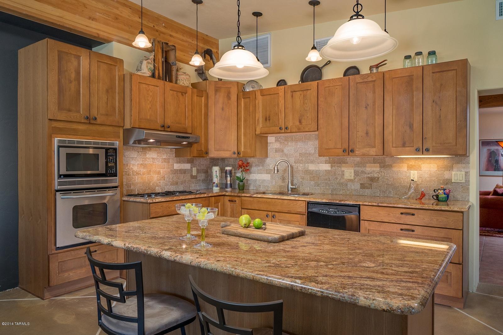 This centrally located brick home has been extensively remodeled to add modern open spaces while maintaining the original charm.  The new 25’ x 25’ family room addition opens from the new kitchen.  The master bedroom is large with plenty of windows. The bathrooms have been remodeled too.  Enjoy the large living room with fireplace.  The home includes a 3-car carport, new porch with rolling screens, and a sparkling pool. Improvements include newer roof, 2 newer heat pumps and 2 new evap coolers in 2012.  Located on ¼ acre in Central Tucson it is close to shopping and the U of A. Washer, Dryer & refrigerator included.