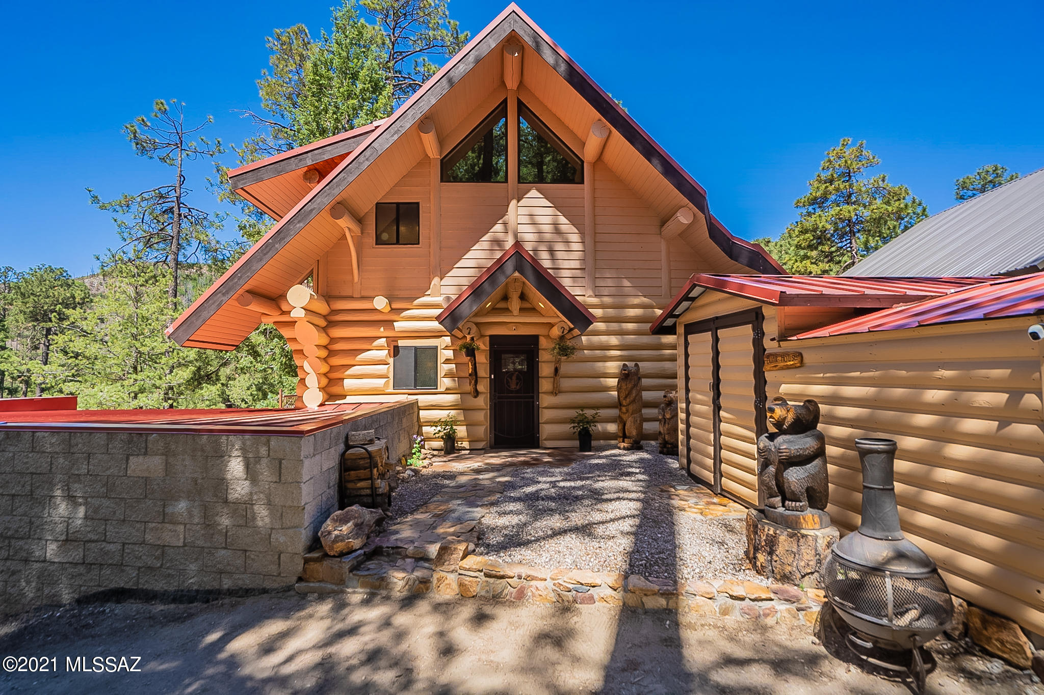 Spectacular fully furnished whole-log cabin of Canadian red cedar offers all season living or weekend escapes.  Nestled among mature pine and aspens on a double lot with year round access, this tri-level beauty has lush forest and mountain views from three covered decks.  Built in 2004, its special features include a two story great room, wood burning or gas fireplace with custom metal surround, newly finished wood flooring, granite kitchen counter, stainless steel appliances, one of a kind island with bar seating.  Private upper level master suite and two additional bedrooms on lower level all with awesome views.  Lower level offers rental possibilities (see floor plan).  Other bonuses: bathrooms on each level, generous storage, 3 car garage and generator.  This is a truly special home.
