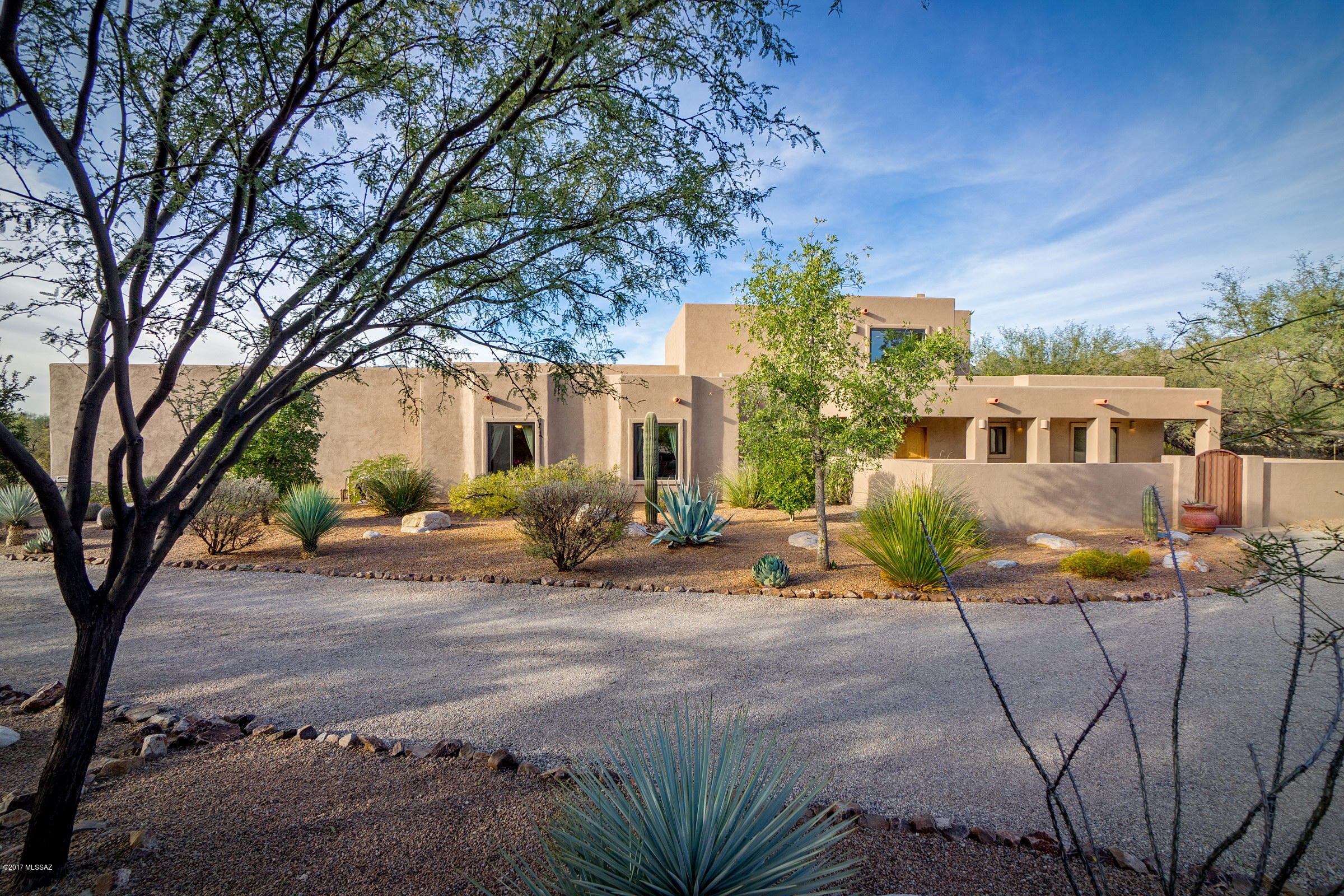 Fabulous 5BR/3.5BA Contemporary Santa Fe on 3.62 acre horse property with easy access to wash and trail. Meticulously maintained 4,178 sqft with many updates including travertine tile flooring, SS appliances, fresh paint inside & out, and recoated roof. Gourmet kitchen with granite counters, built-in refrig, Viking range, double ovens & warming drawer, large center island with prep sink & walk in pantry.  Entertainment room with wet bar has sliding glass doors leading to professionally landscaped yard & pool. Private second story master suite showcases magnificent Catalina Mountain views to be enjoyed from sitting area & gas fireplace shared by spa-like bath with elevated Jacuzzi tub and Jacuzzi steam shower. Large laundry/craft room, oversized 3-car garage with storage room and much more!